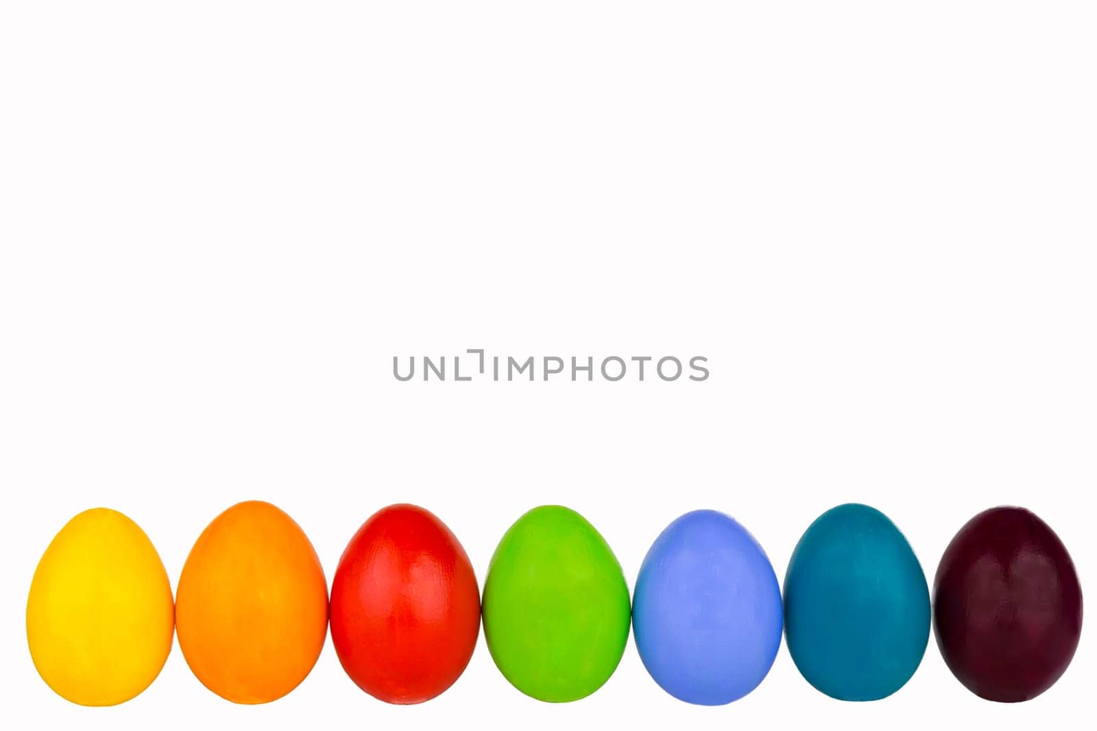 Colorful Easter eggs in a row at the bottom of the picture