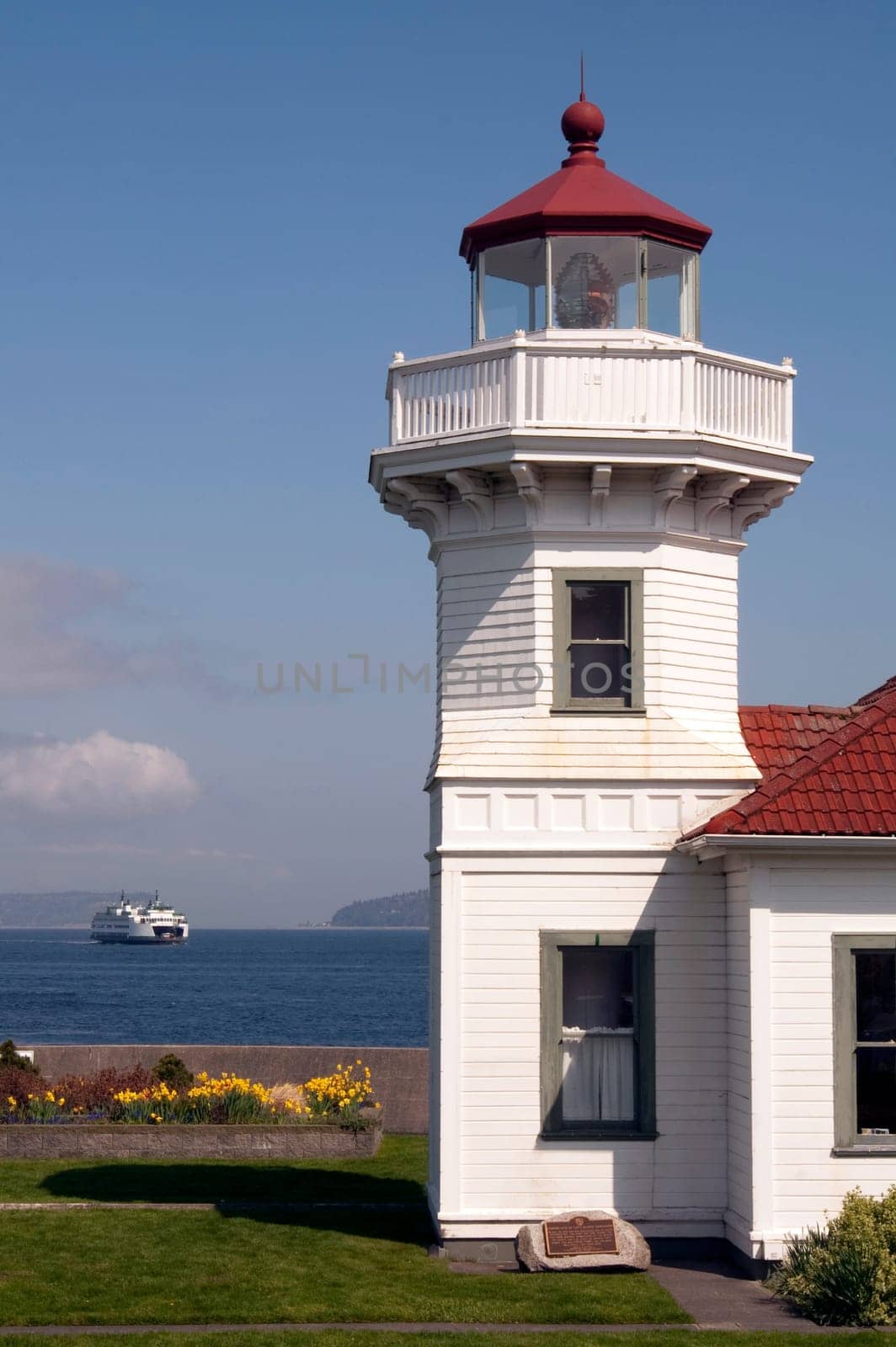 A ferry leaves the dock behind a coastal nautical beacon on puget sound