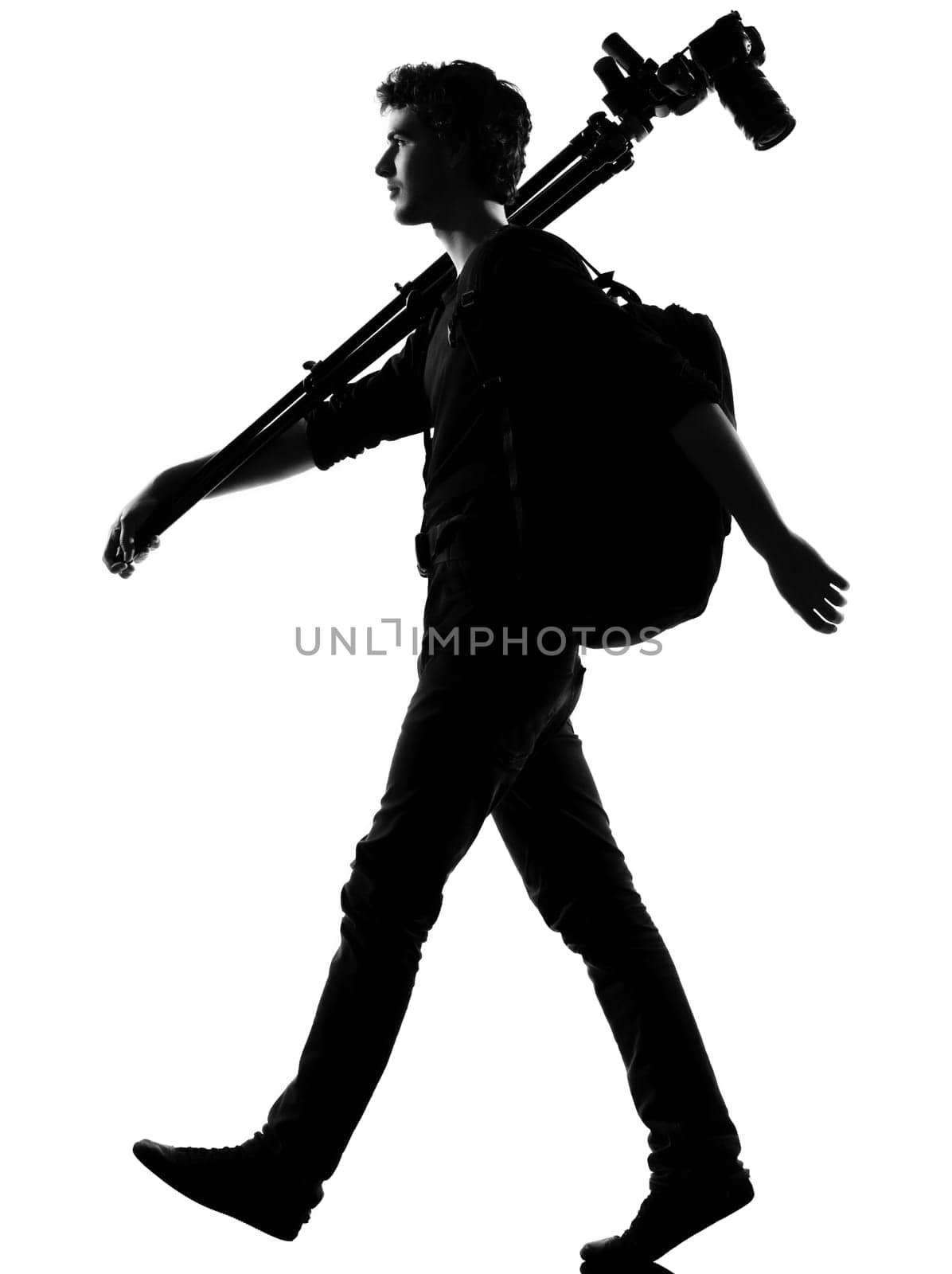 young man photographer silhouette in studio isolated on white background