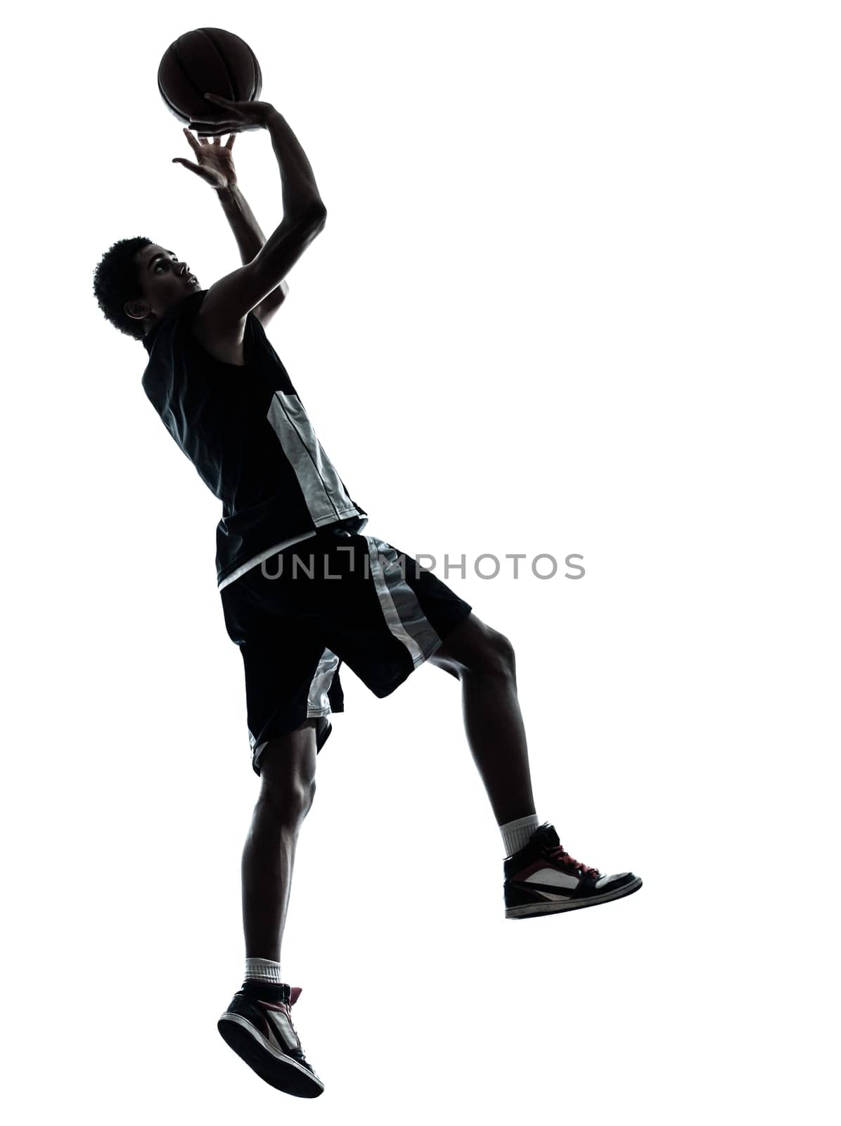 one young man basketball player silhouette in studio isolated on white background