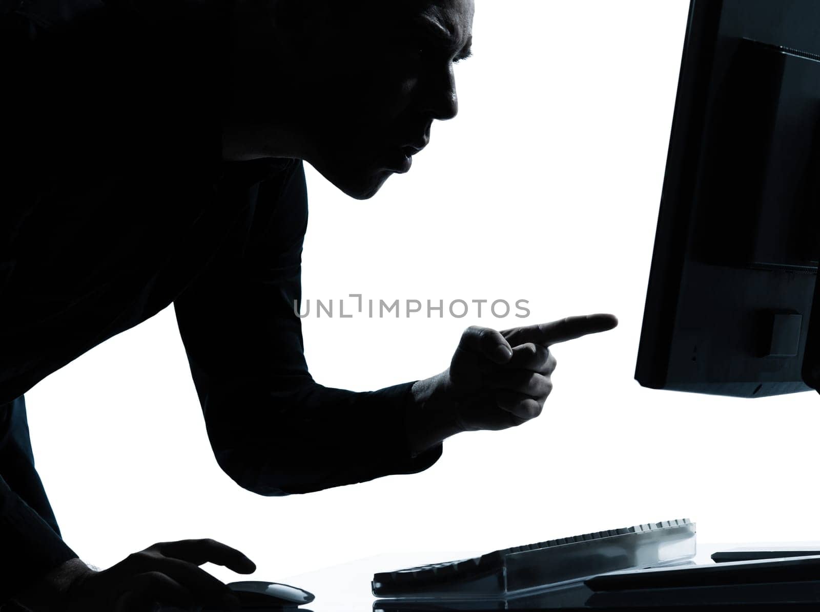 one caucasian business man computing computer angry displeased portrait silhouette in studio isolated on white background