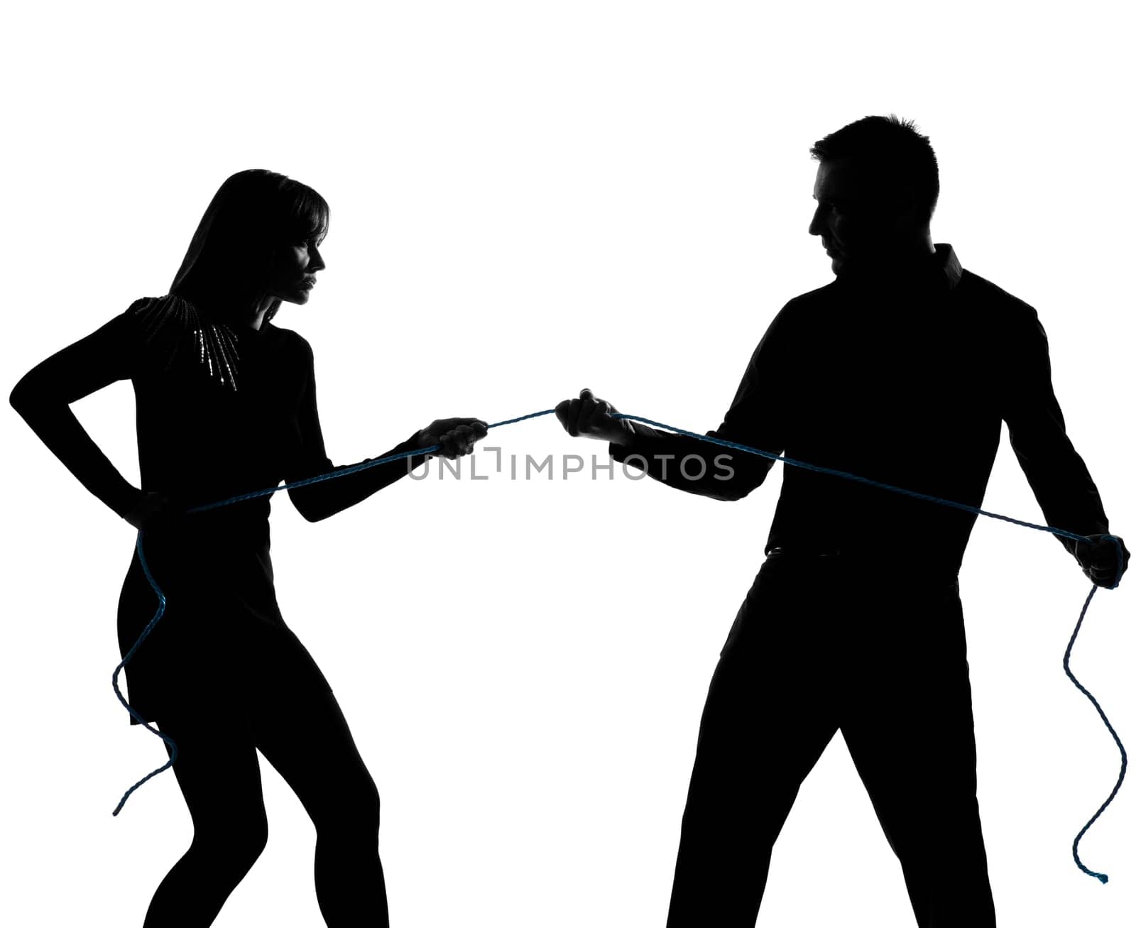 one caucasian couple man and woman pulling a rope in studio silhouette isolated on white background