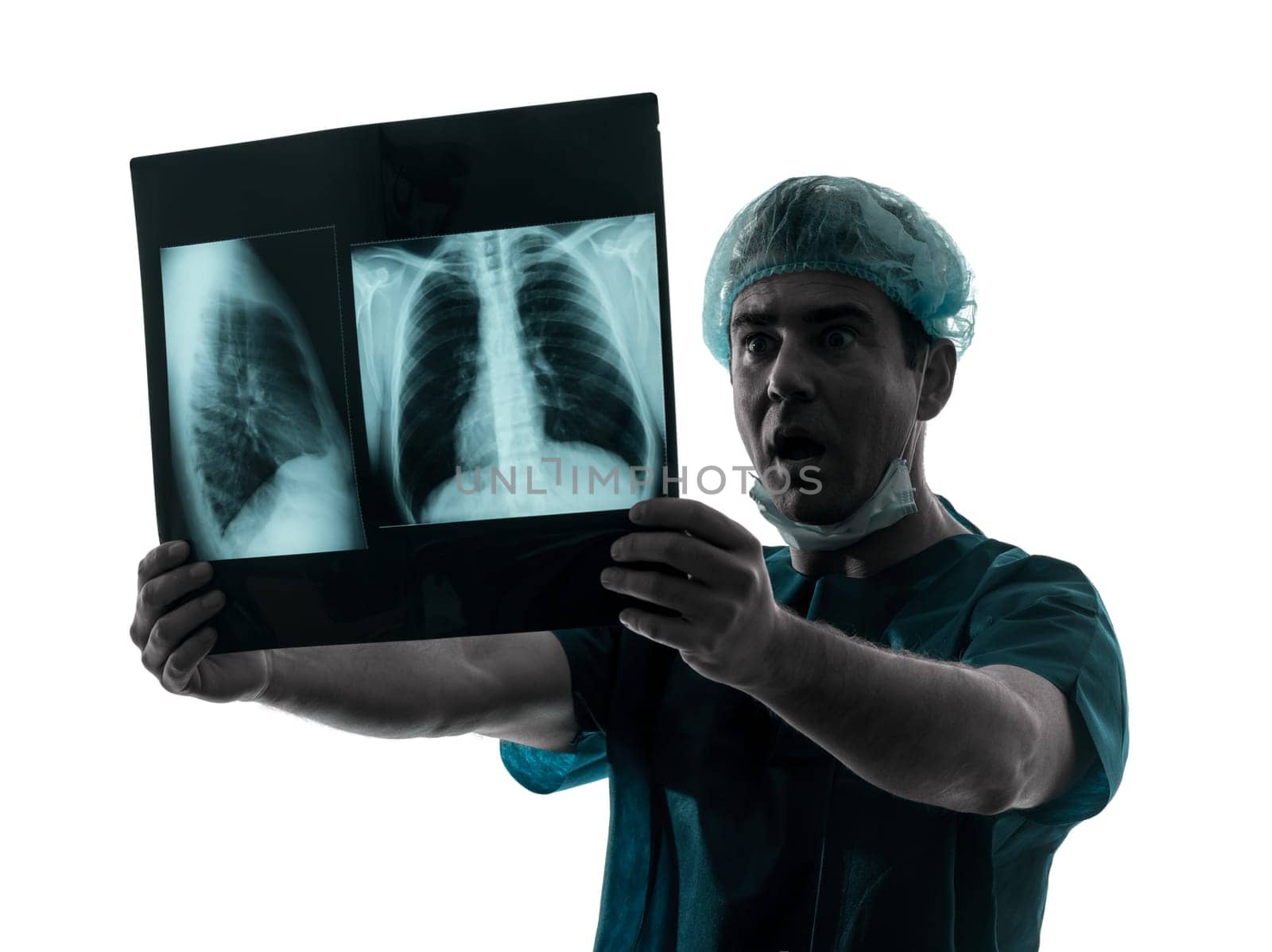 one caucasian man doctor surgeon radiologist medical surprised examining lung torso x-ray image silhouette isolated on white background