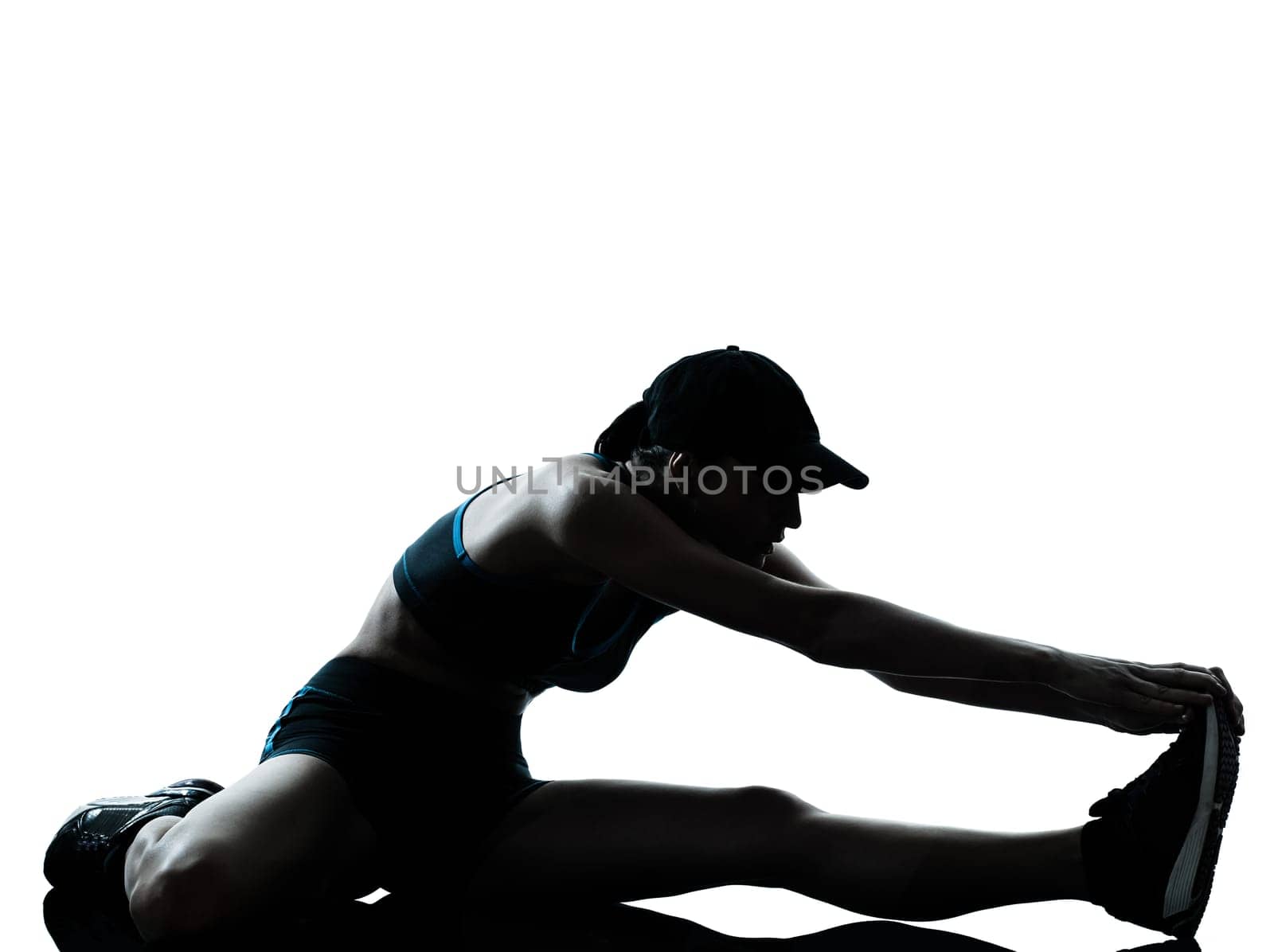 one caucasian woman runner jogger stretching legs warming up in silhouette studio isolated on white background