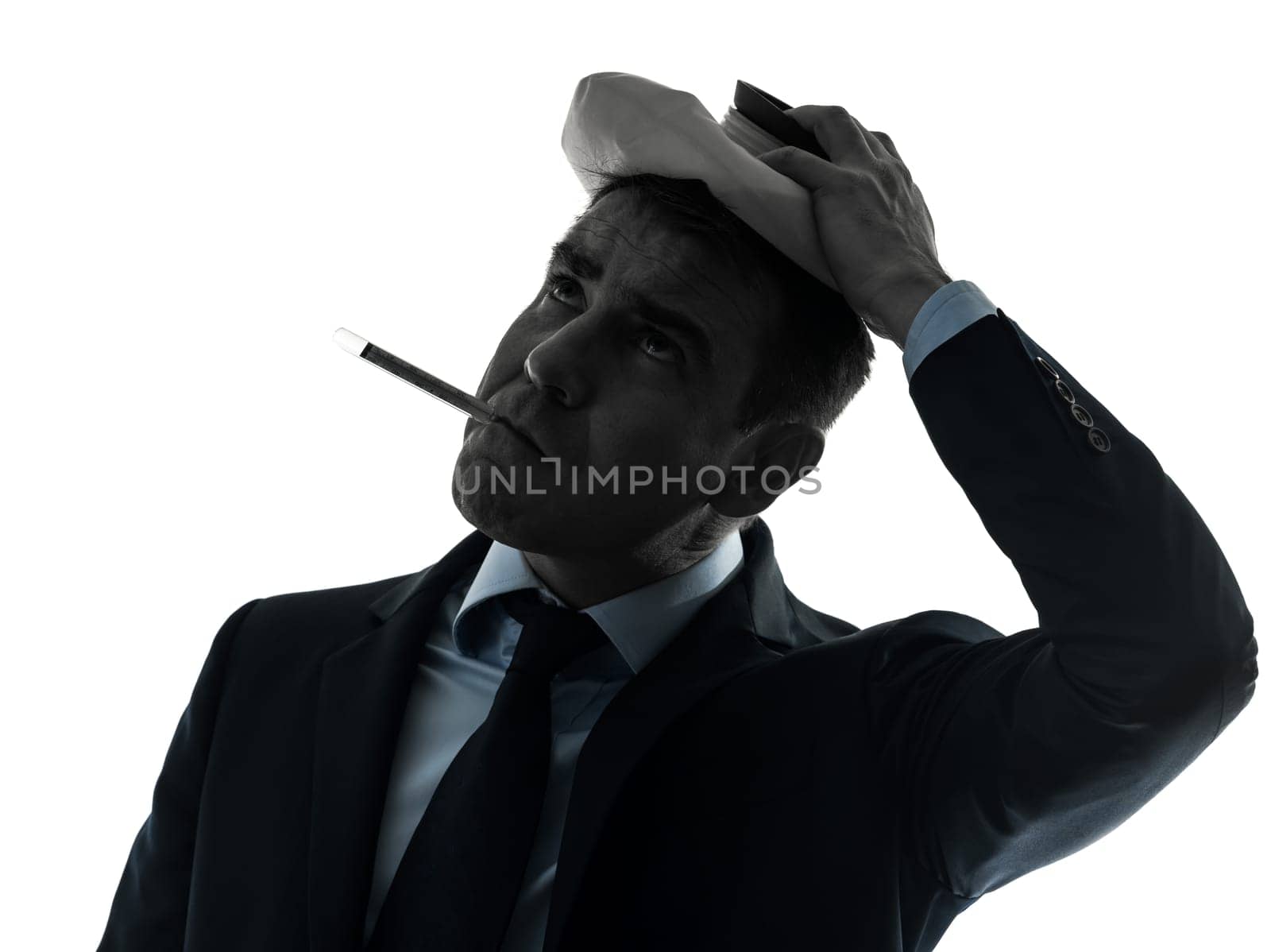 one caucasian man sick with thermometer and ice pack portrait in silhouette studio isolated on white background