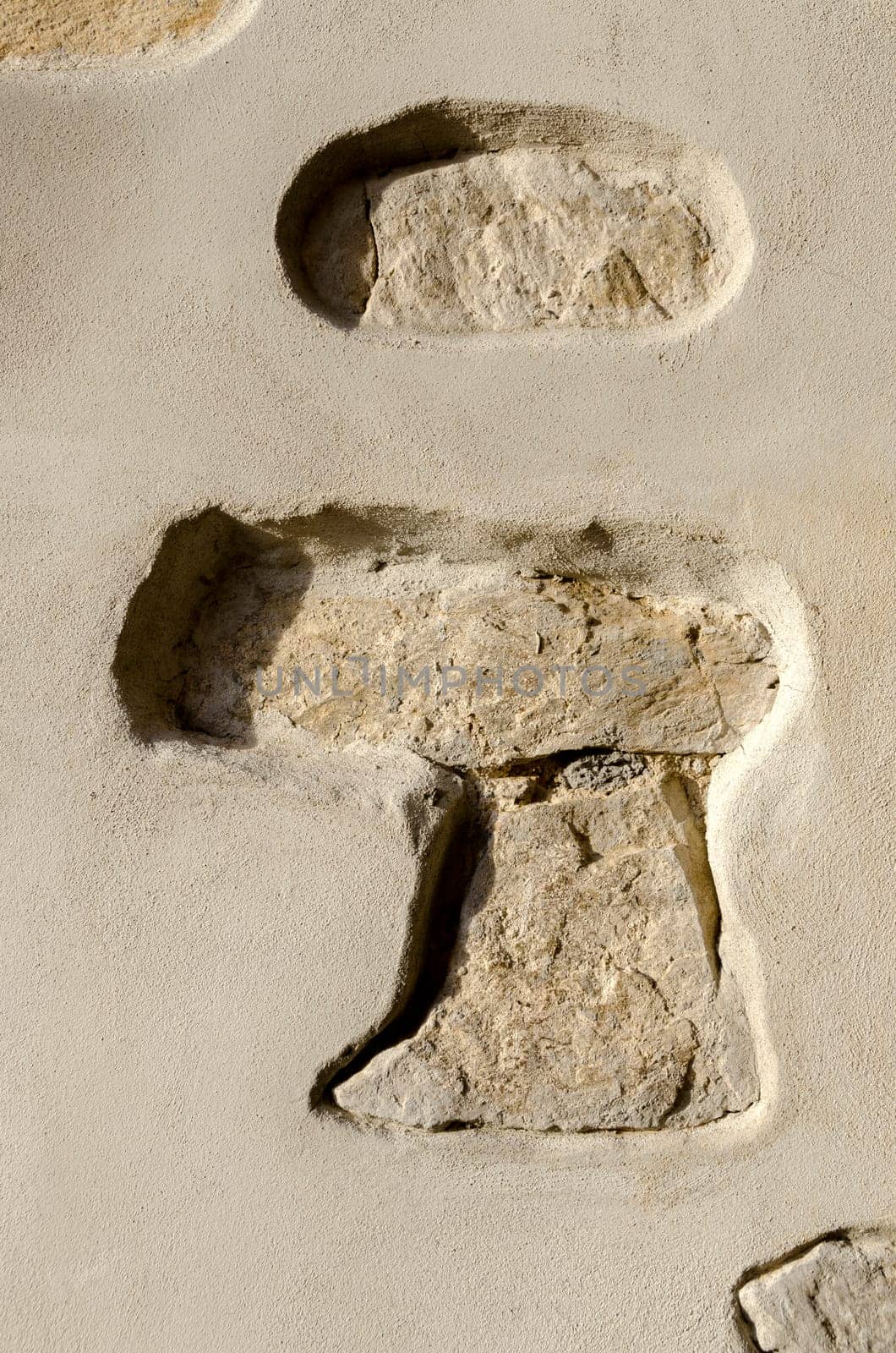 stones embedded in the plaster of a wall