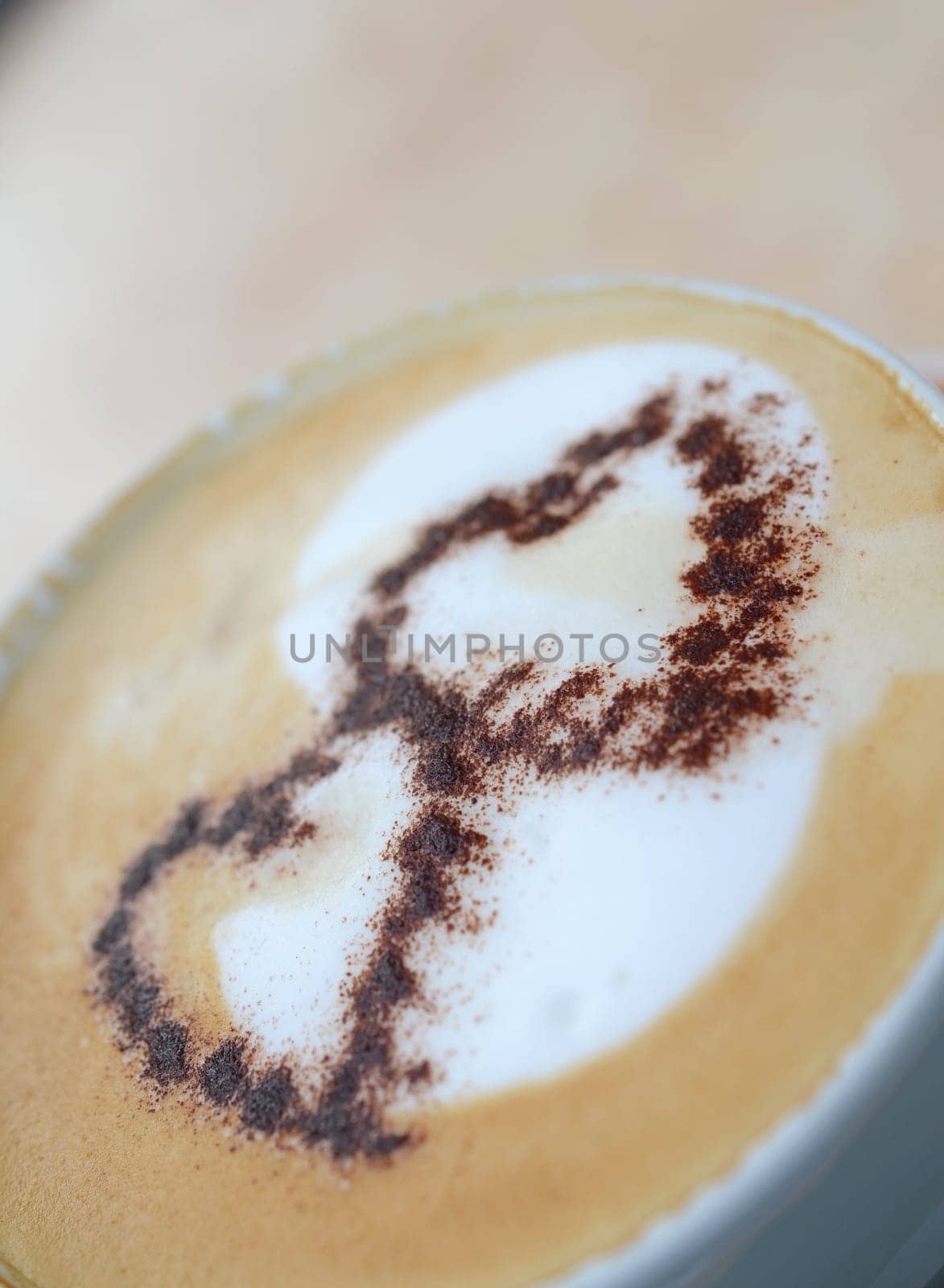 Two heart shapes of chocolate powder on a cappucchino