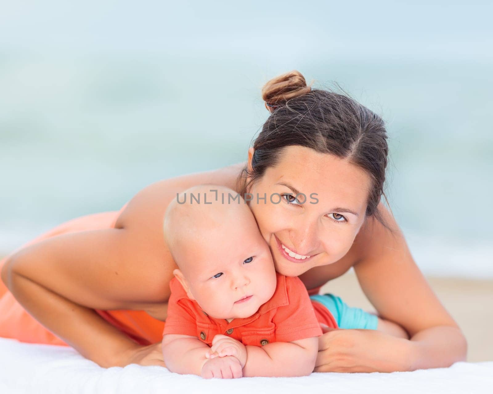 Baby and mom are relaxing on sunbed