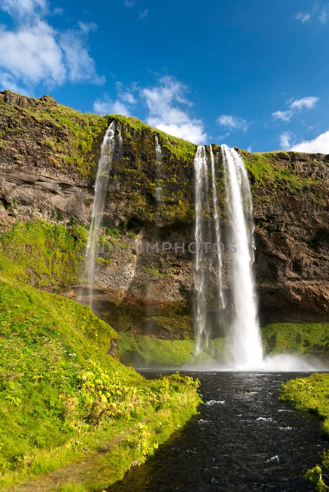 Seljalandsfoss waterfall with rainbow in Iceland