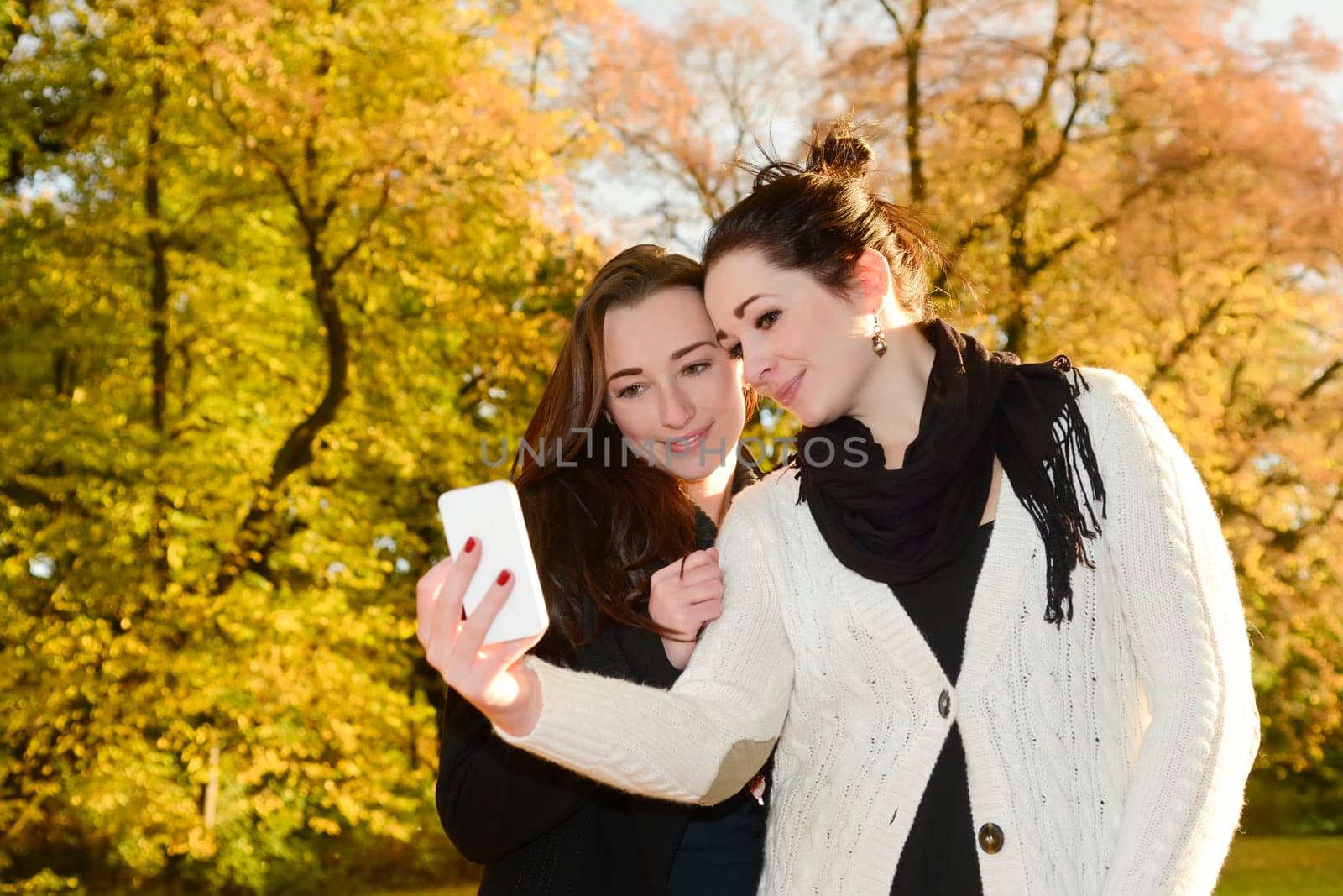 Girlfriends with smartphones