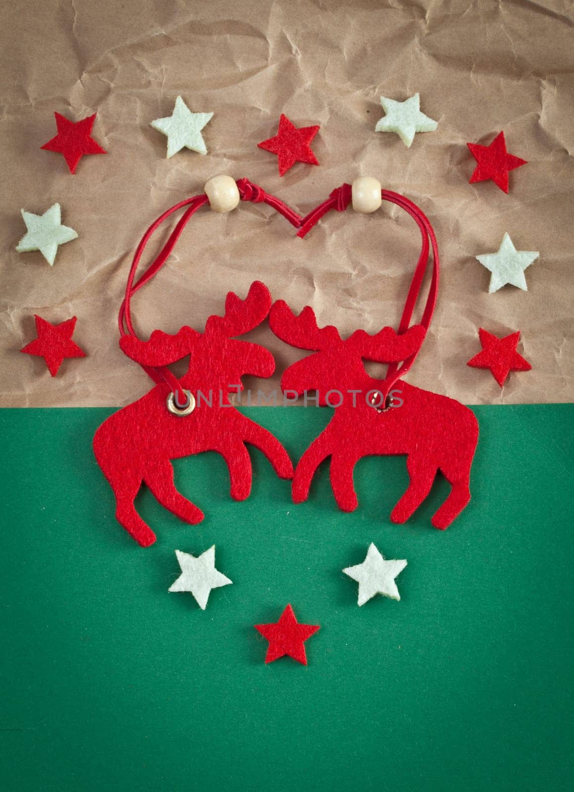 Red elk made of felt on a green background