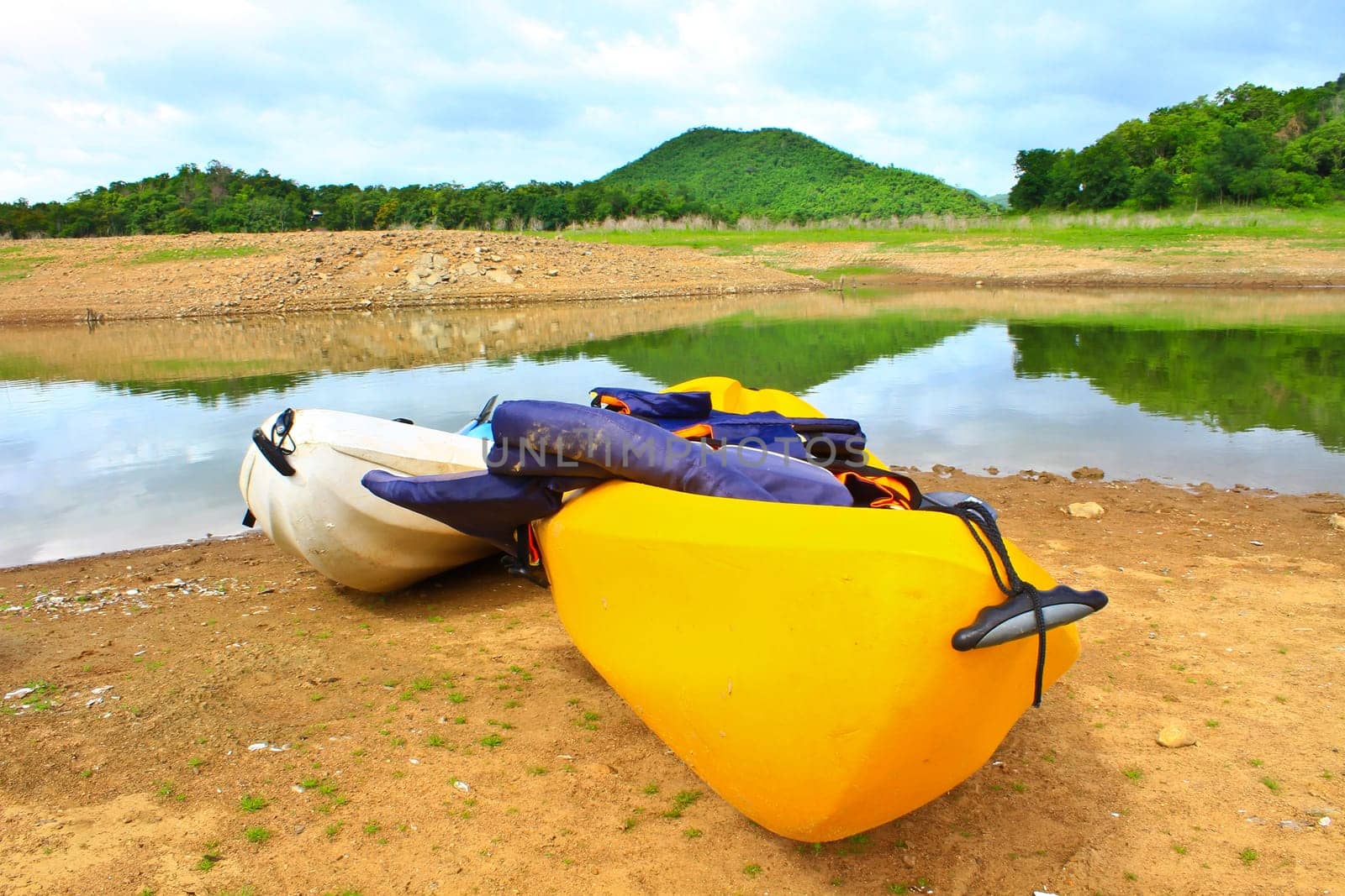 Kayaks, canoe  on the edge of the water in Lake Dam Kaeng Krachan, Thailand