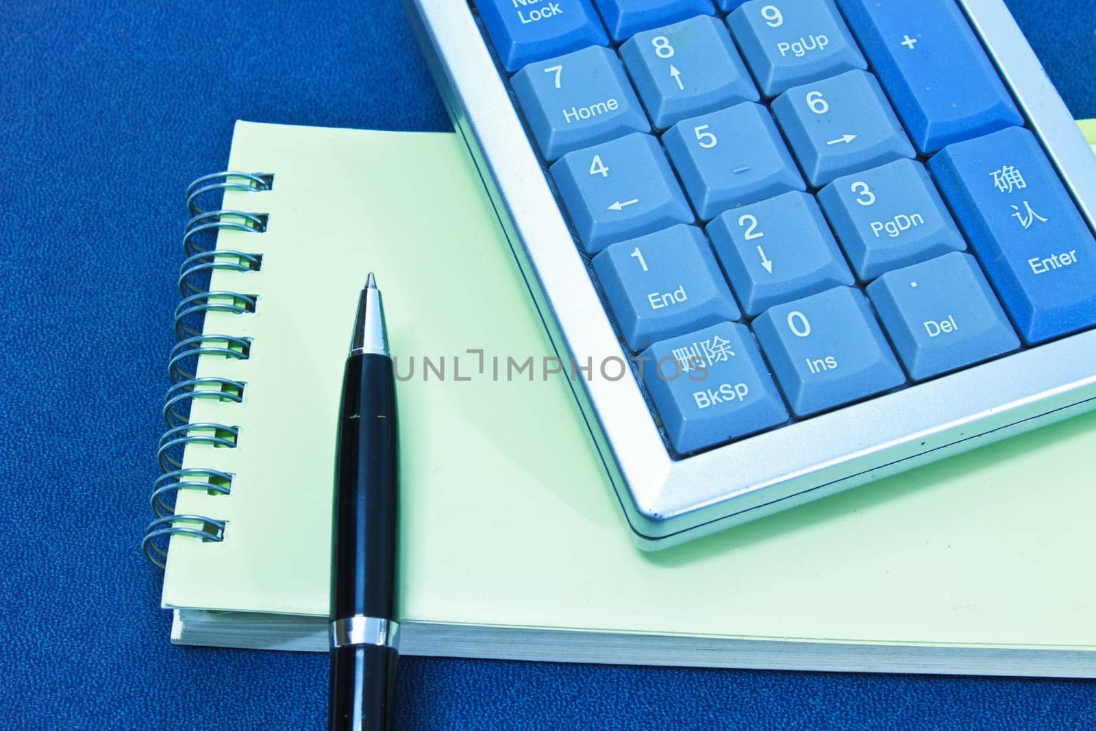 calculator and pen on blank notebook. Shot on background