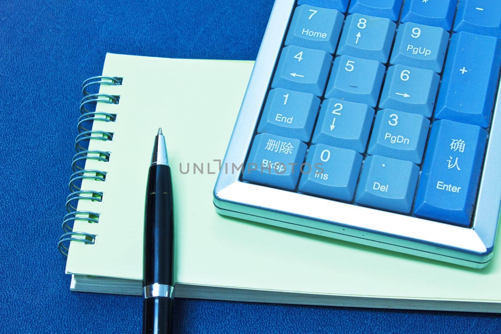 calculator and pen on blank notebook. Shot on background