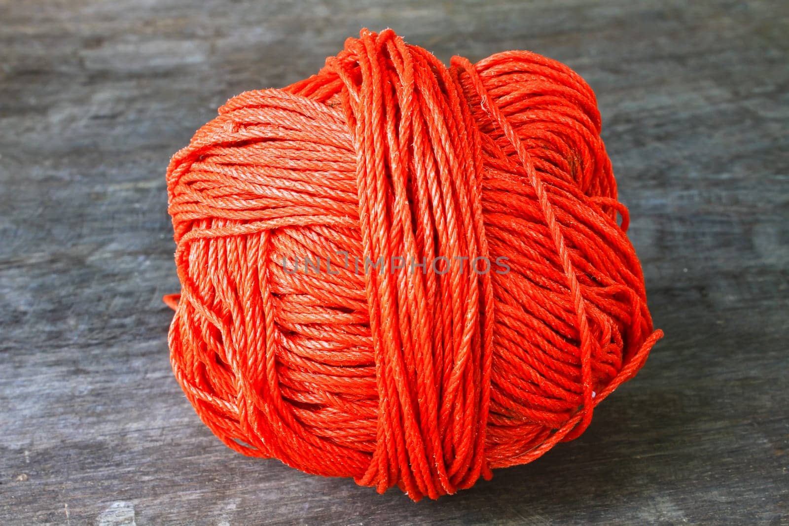 Bunch of red nylon rope on a wooden background