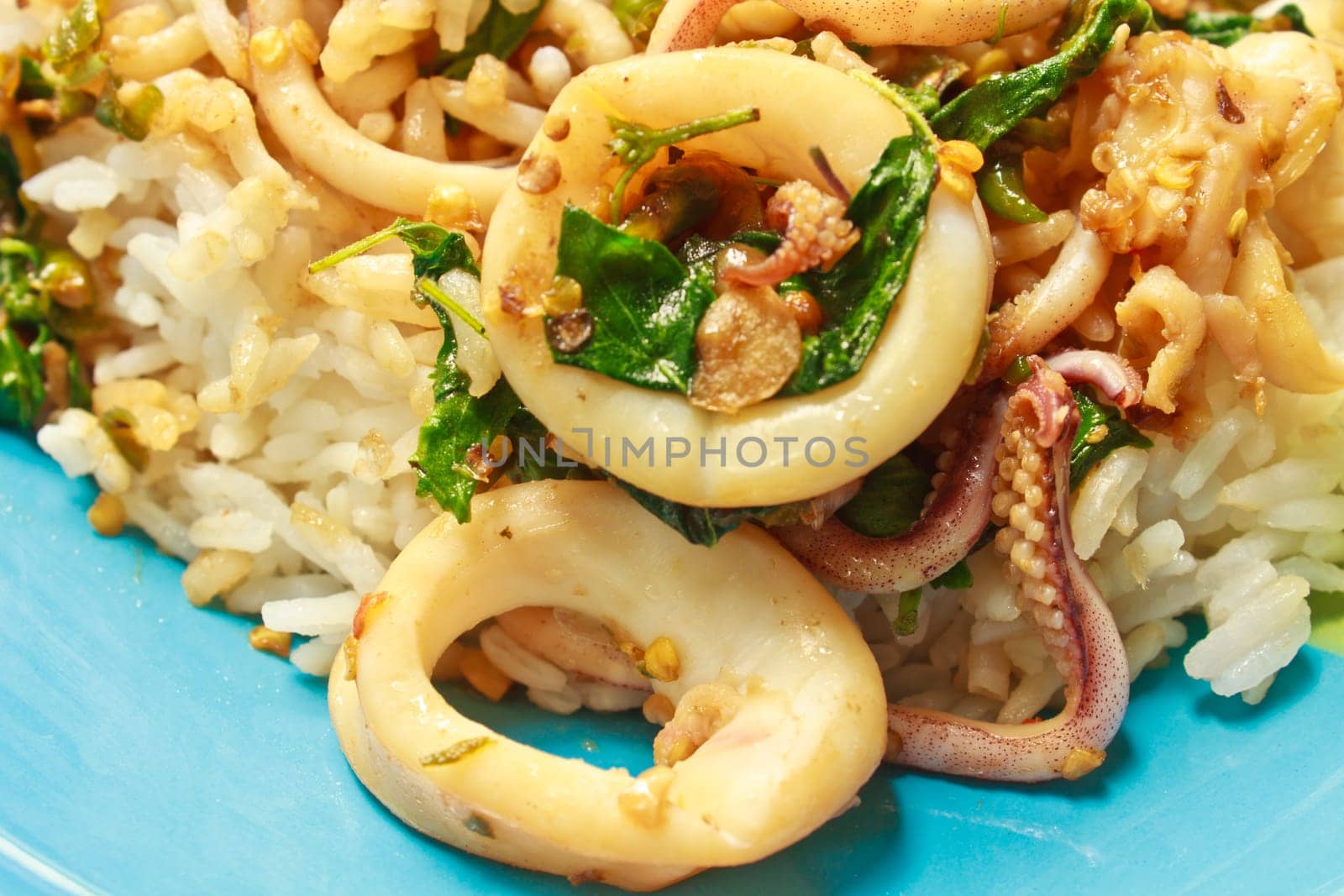 squids fried with chilli pepper and sweet basil on rice,thai food