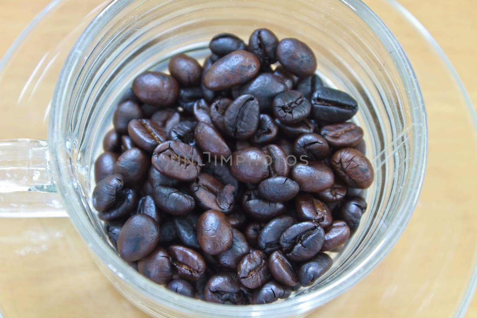 coffee beans in cup on the wood table