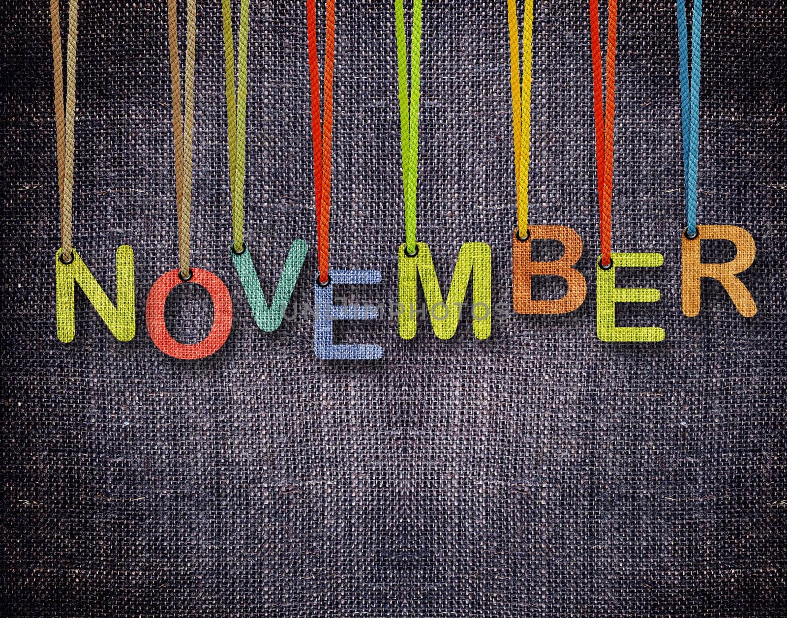 November  letters hanging strings with blue sackcloth background.