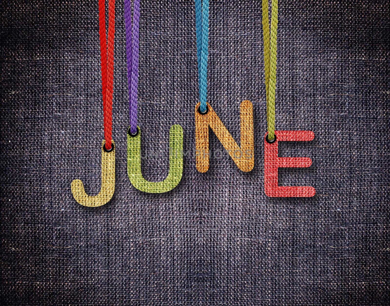 June letters hanging strings with blue sackcloth background.
