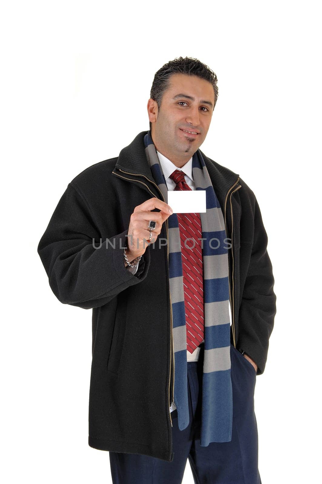 A tall and young businessman standing in a black coat for.white background showing his business card..