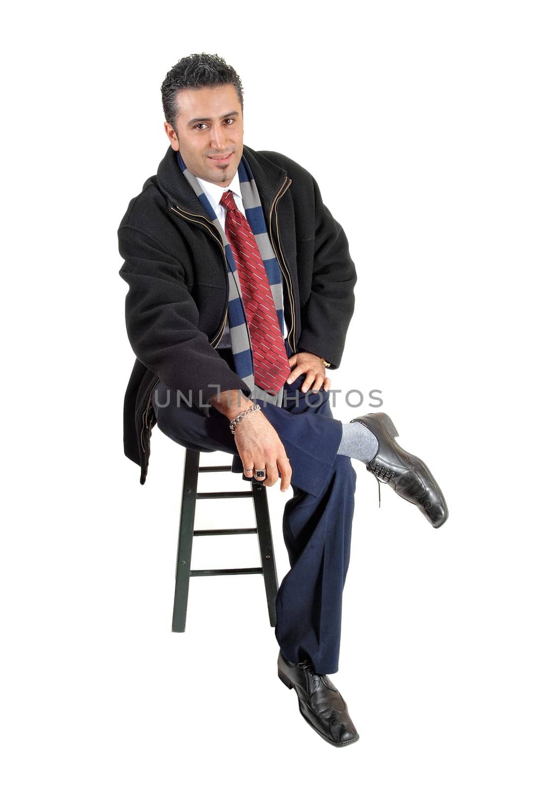A young businessman sitting on a chair .and looking relaxed, for white background..