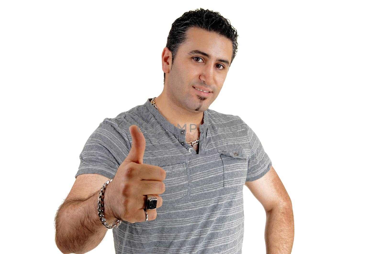 A handsome young man standing for white background, gesturing thump.up for job well done..