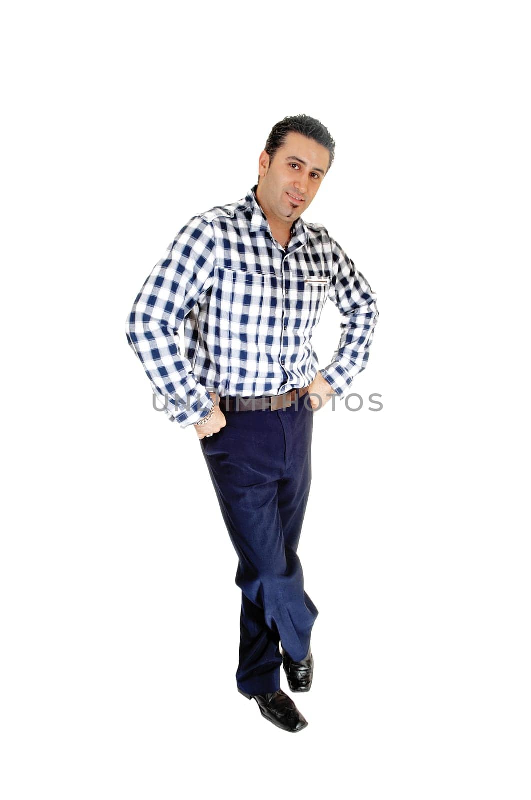 A young tall man standing for white background very relaxed with his.hands in his pocket..