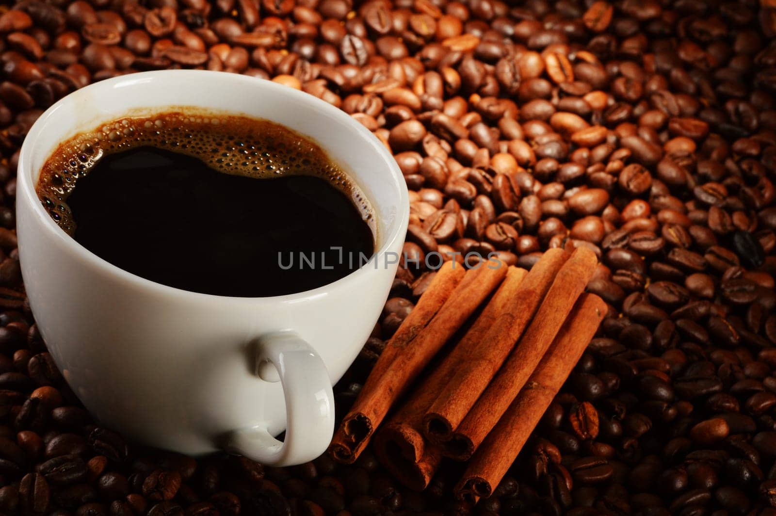 Composition with cup of coffee and beans