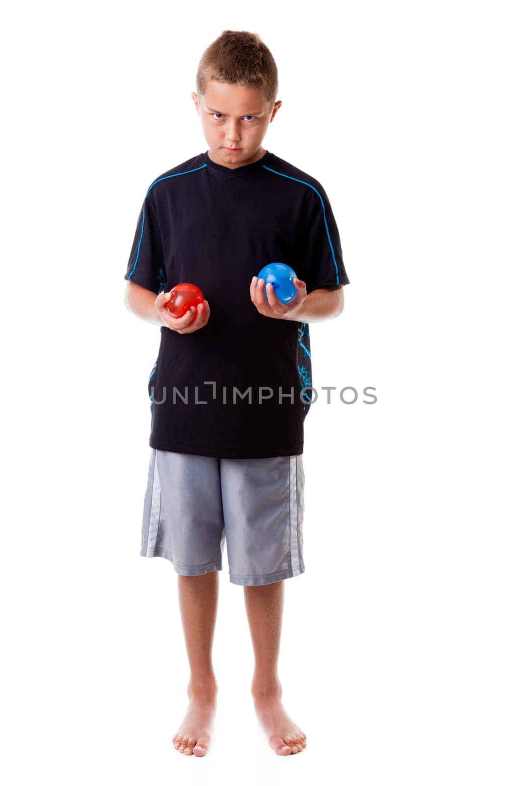 Boy holding water balloons isolated on white background