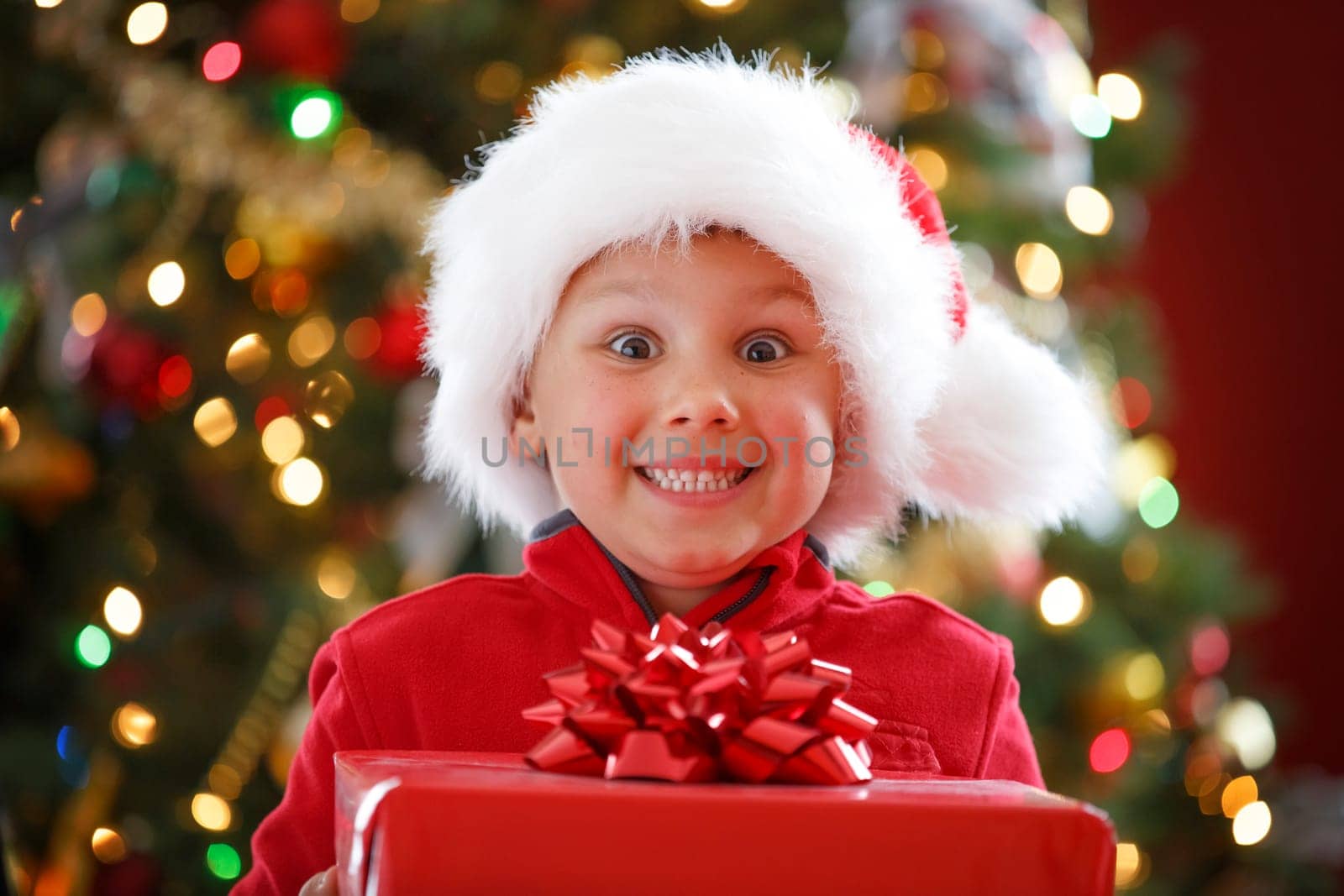 happy boy holding Christmas present