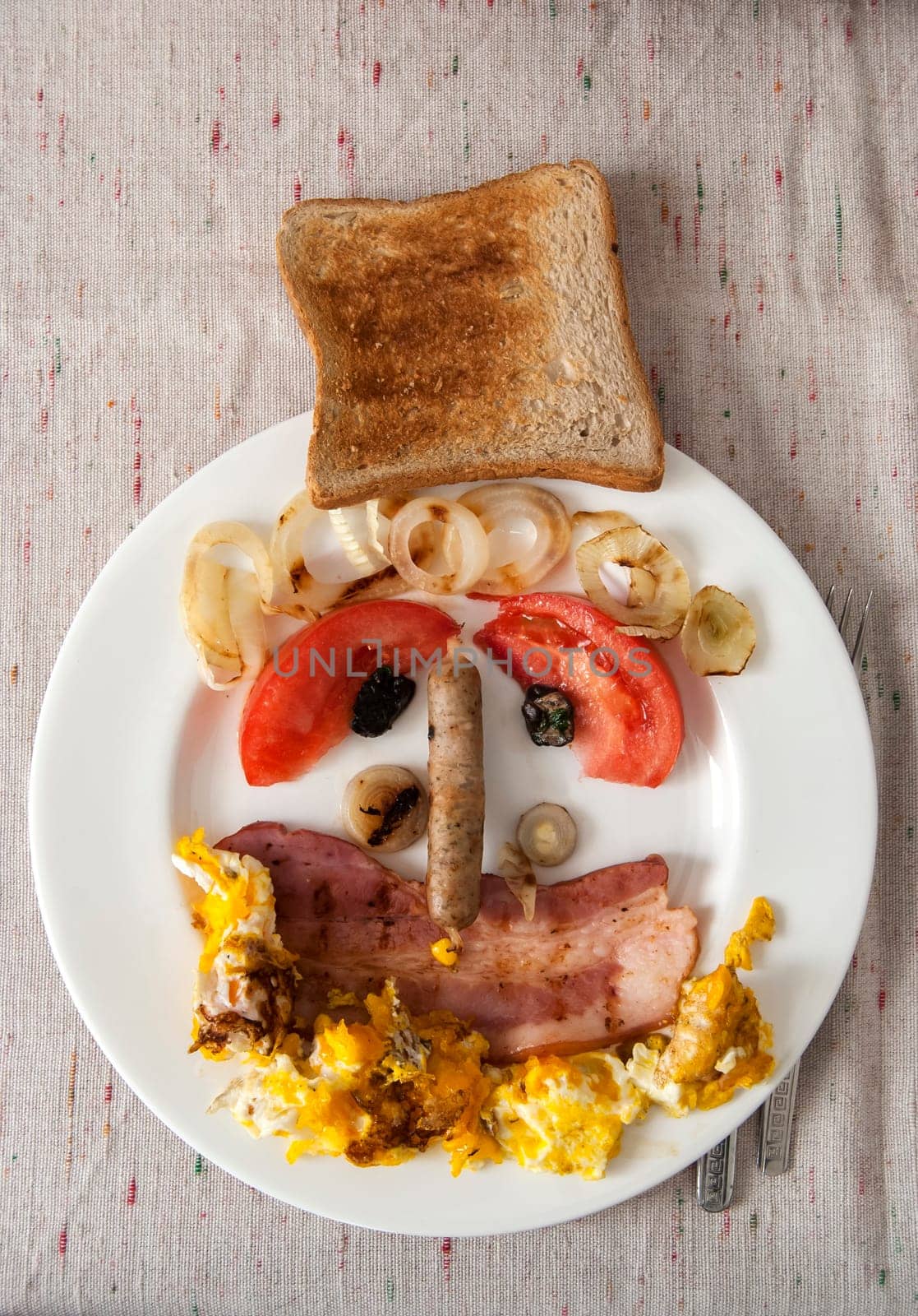 Funny face made from ingredients of English breakfast