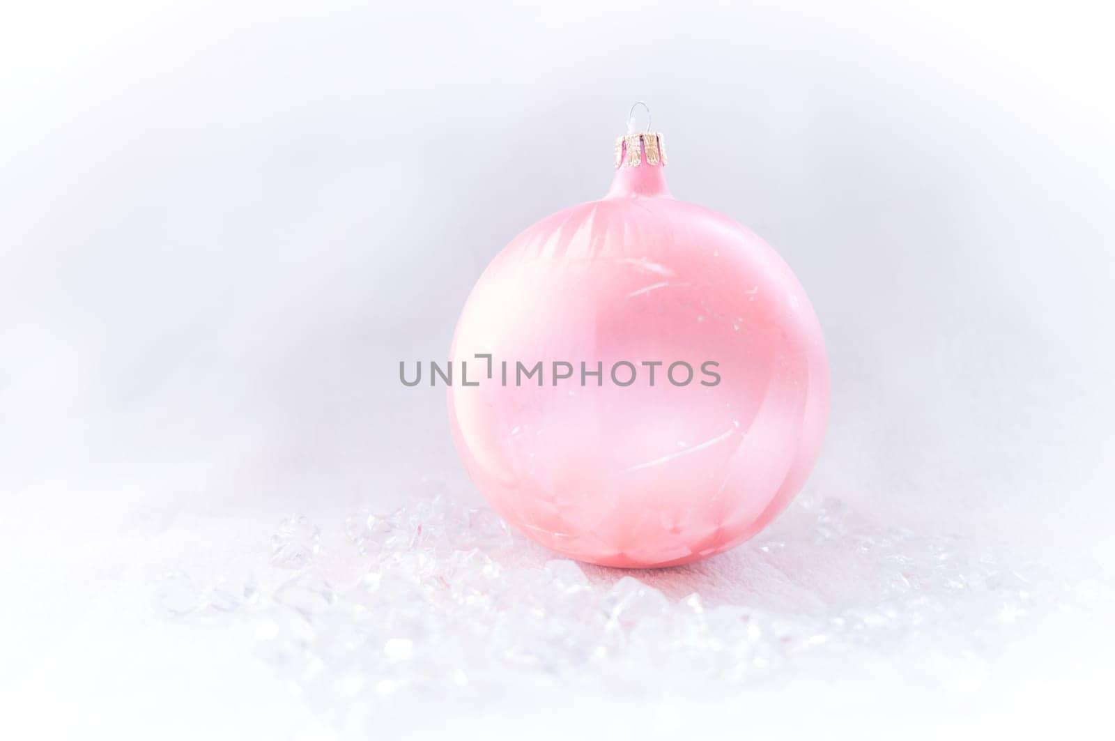 pink Christmas bauble on ice