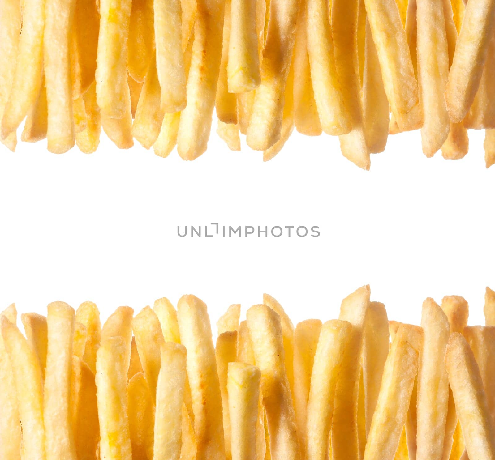 Border of crisp golden French Fries arranged in two rows along the top and bottom of the frame isolated on white with copyspace between