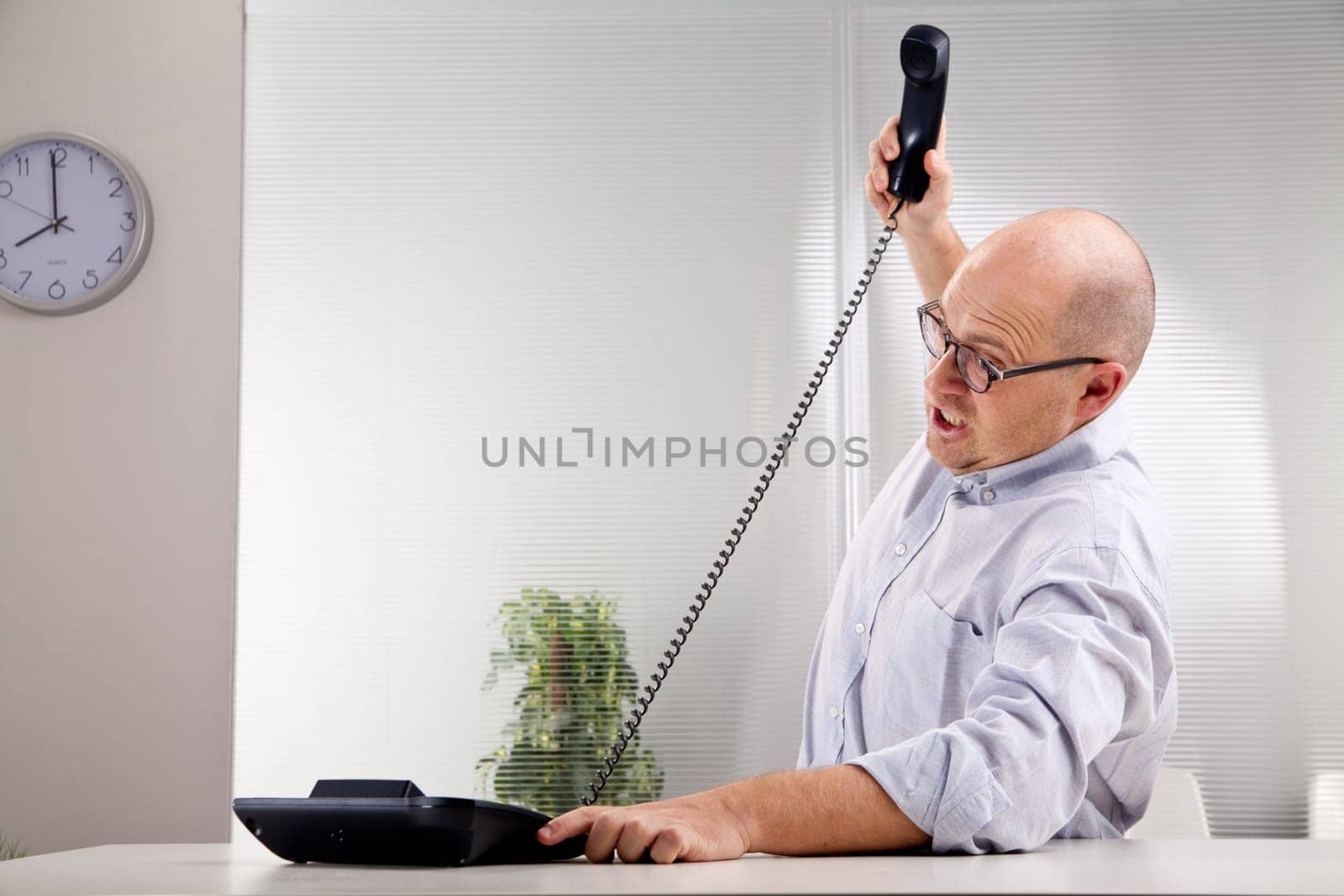 nerdy furious clerk smashing the phone
