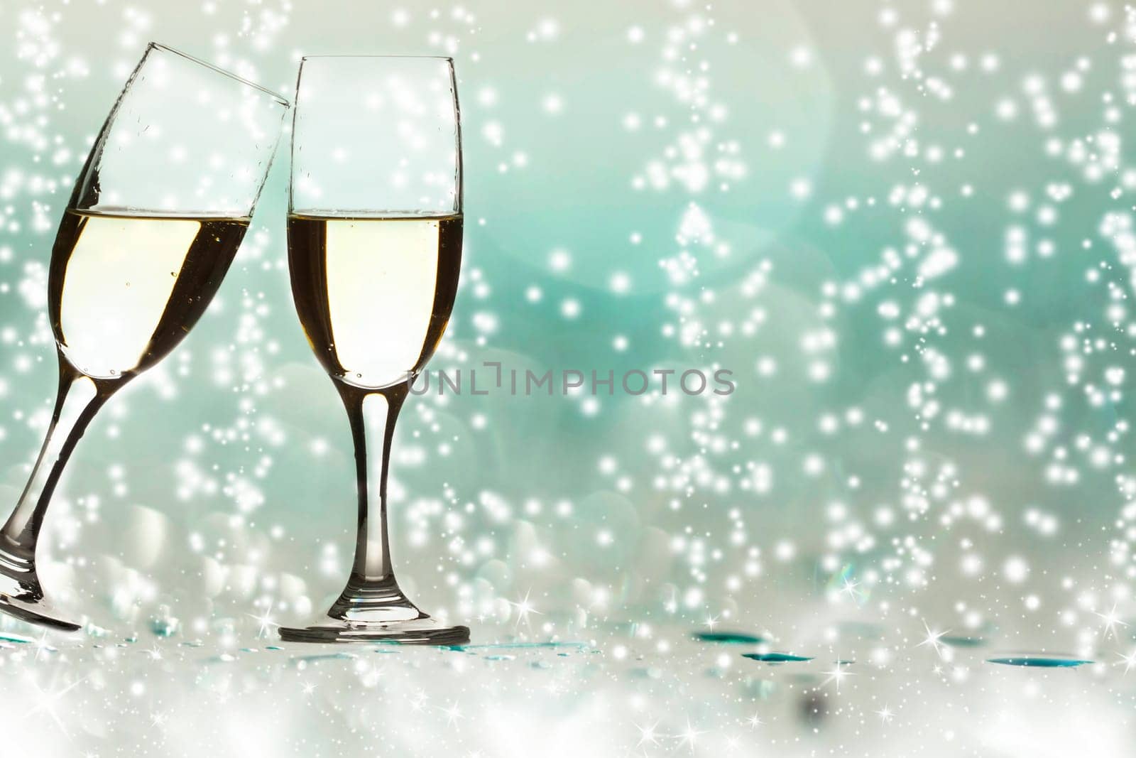 Two glass of champagne and colorful lights