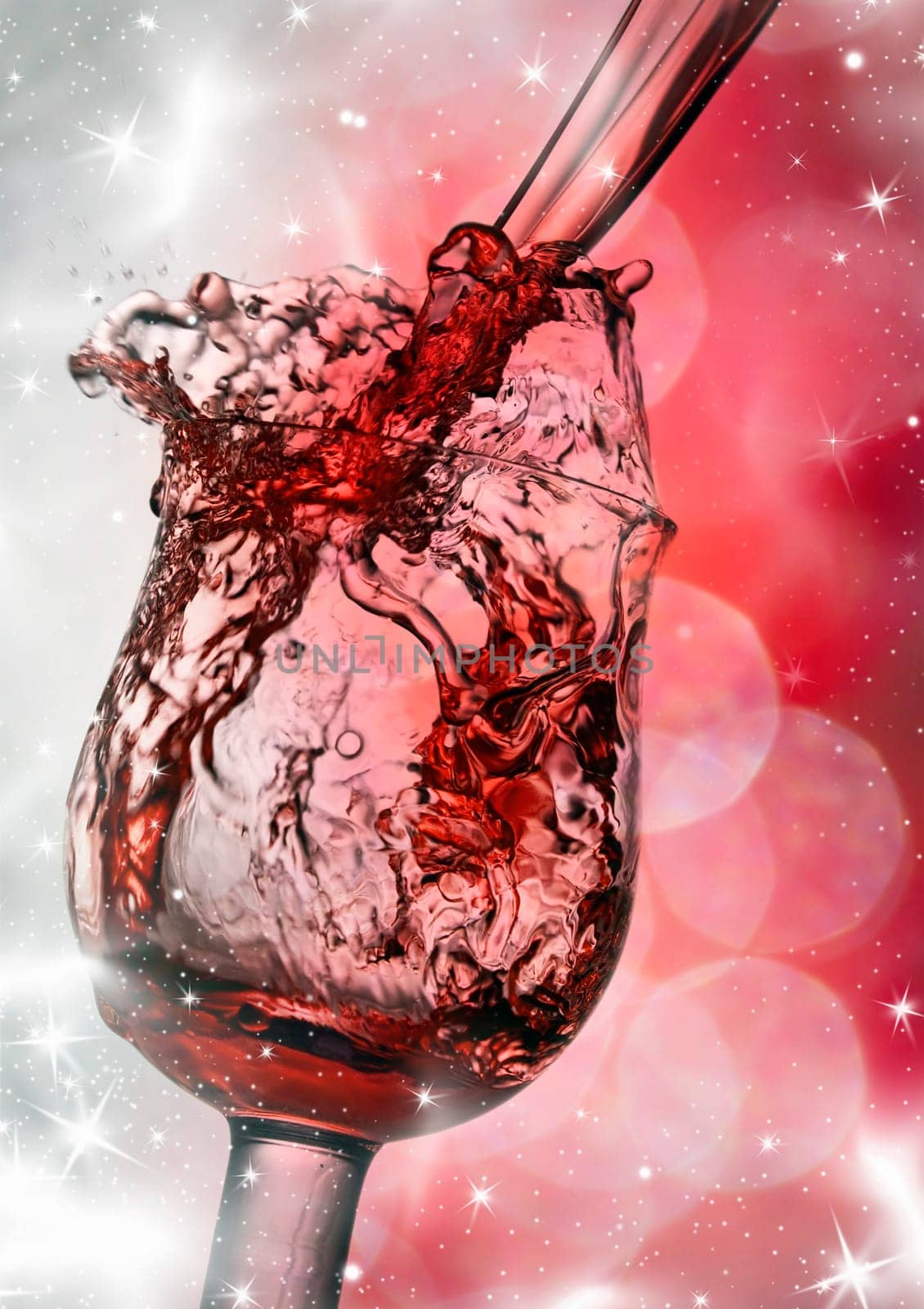 Red wine against silvery fireworks and holiday lights