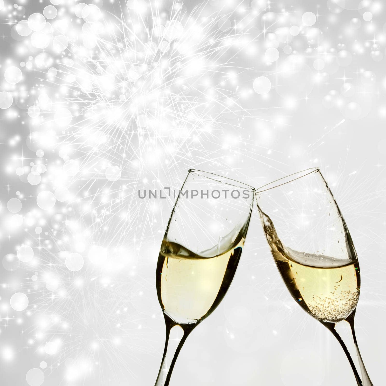 Glasses with champagne against holiday lights