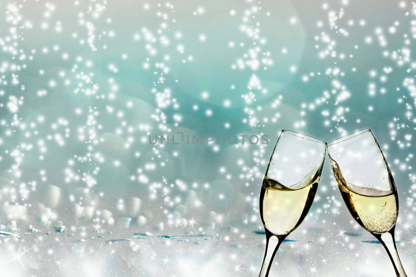 Glasses with champagne against holiday lights