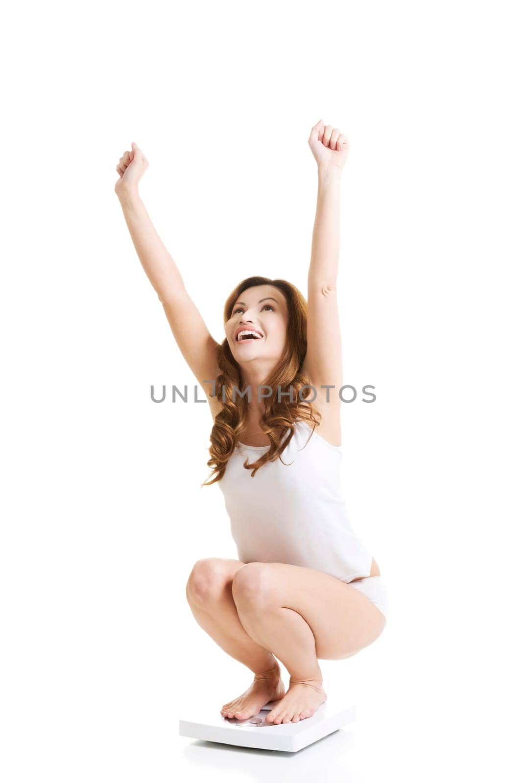 happy woman on scale. isolated on white.