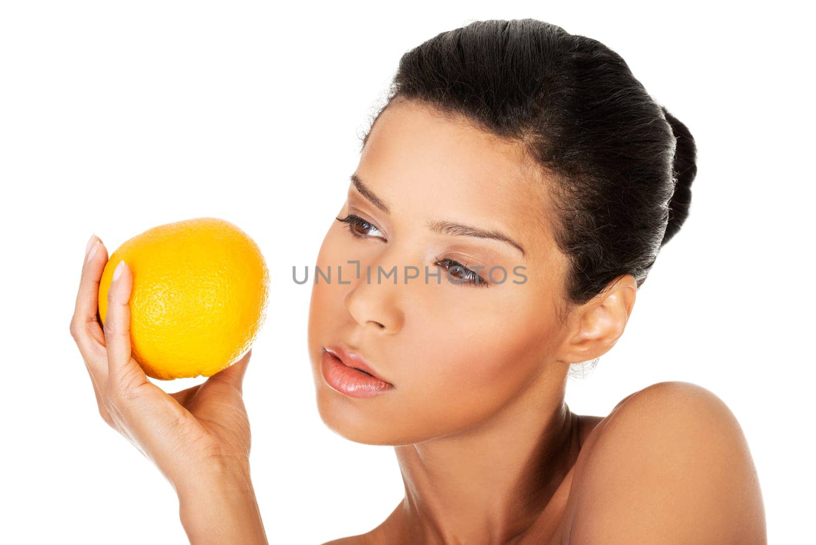 young beautiful spa woman with orange in her hand,isolated on white