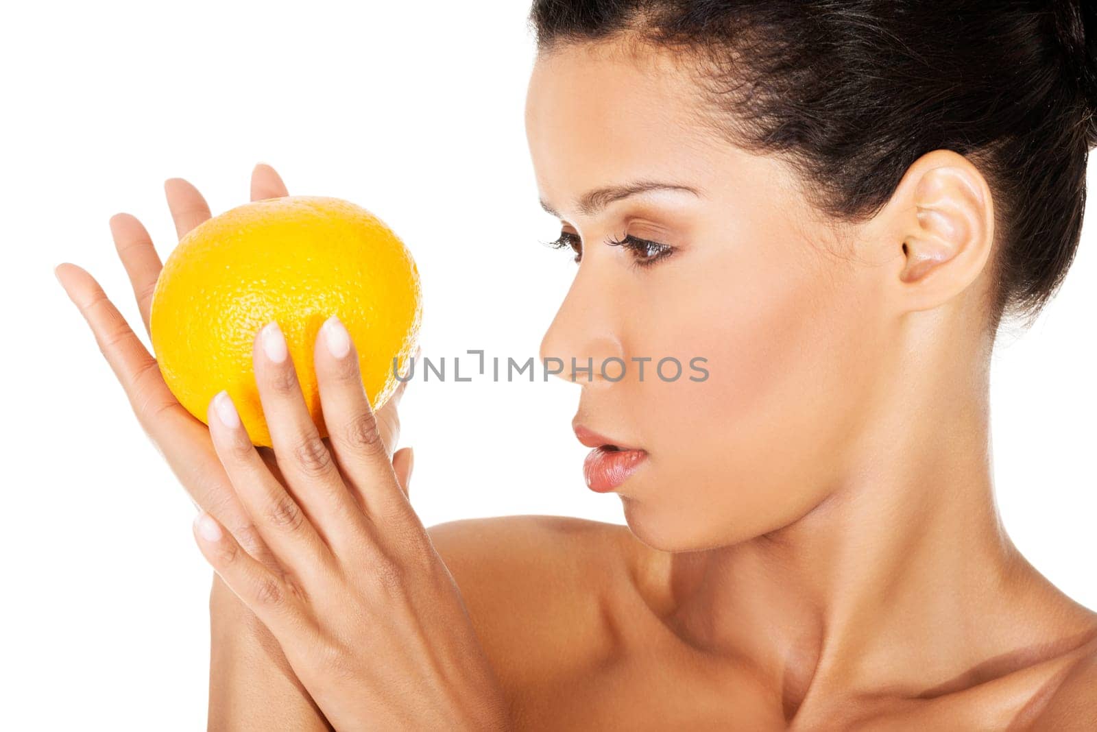young beautiful spa woman with orange in her hand,isolated on white