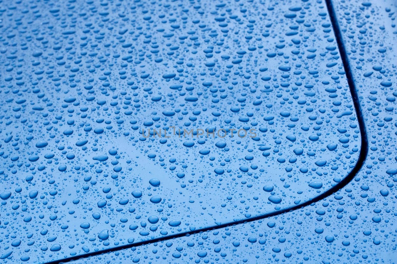 raindrop covered blue vehicle panel abstract