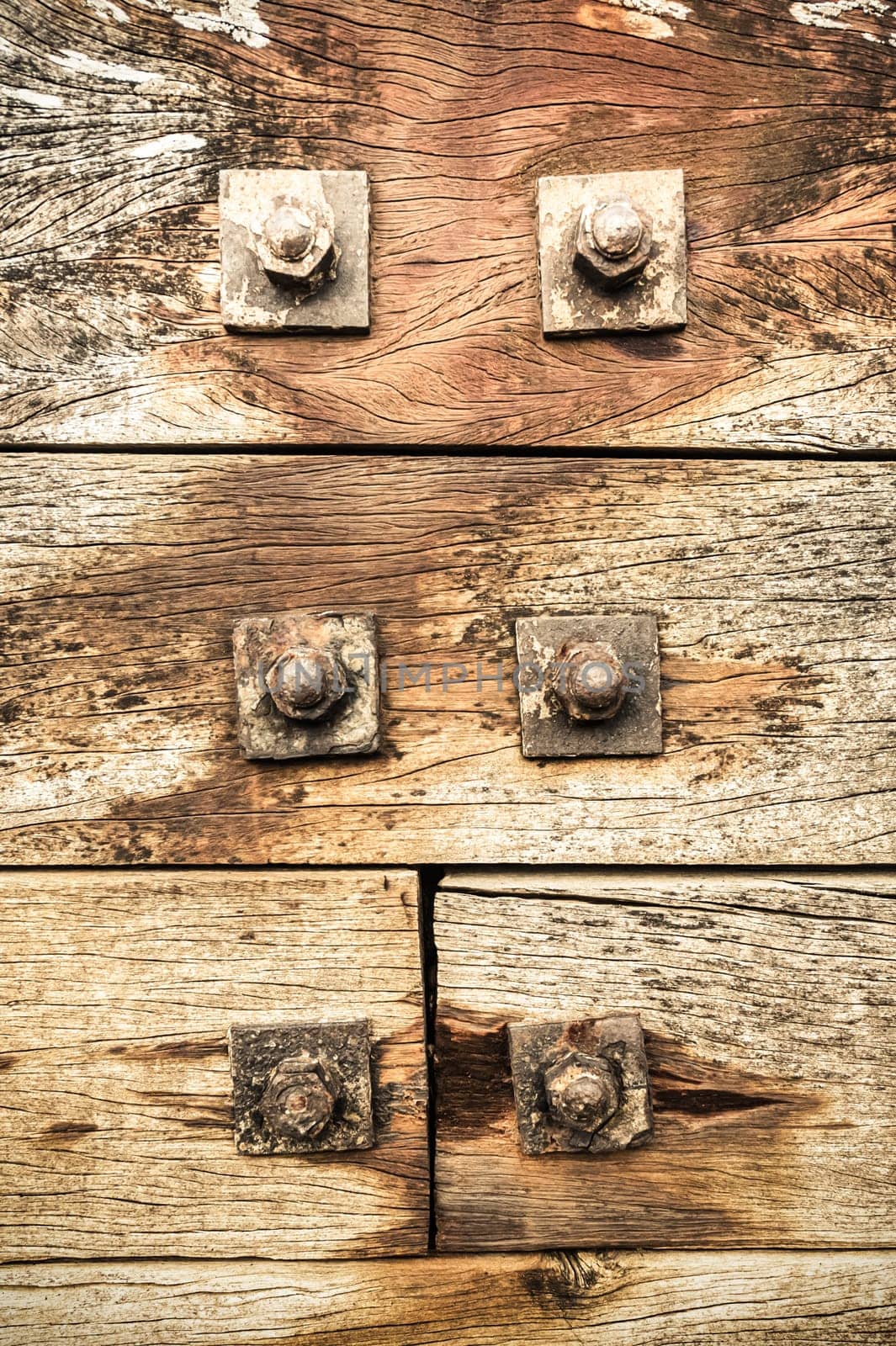 nuts and bolts fixed to grunged wood