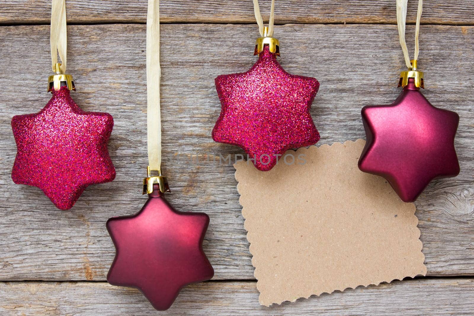 Xmas card on wooden wall with christmas baubles