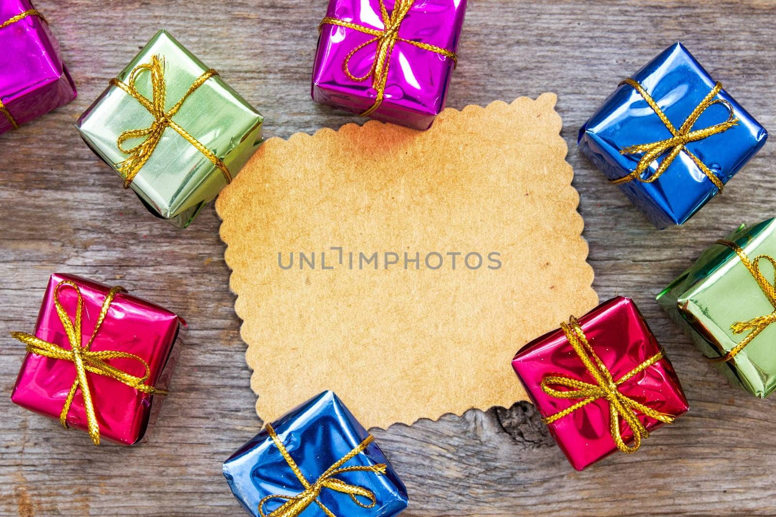 Christmas card on wooden wall with a colorful gifts