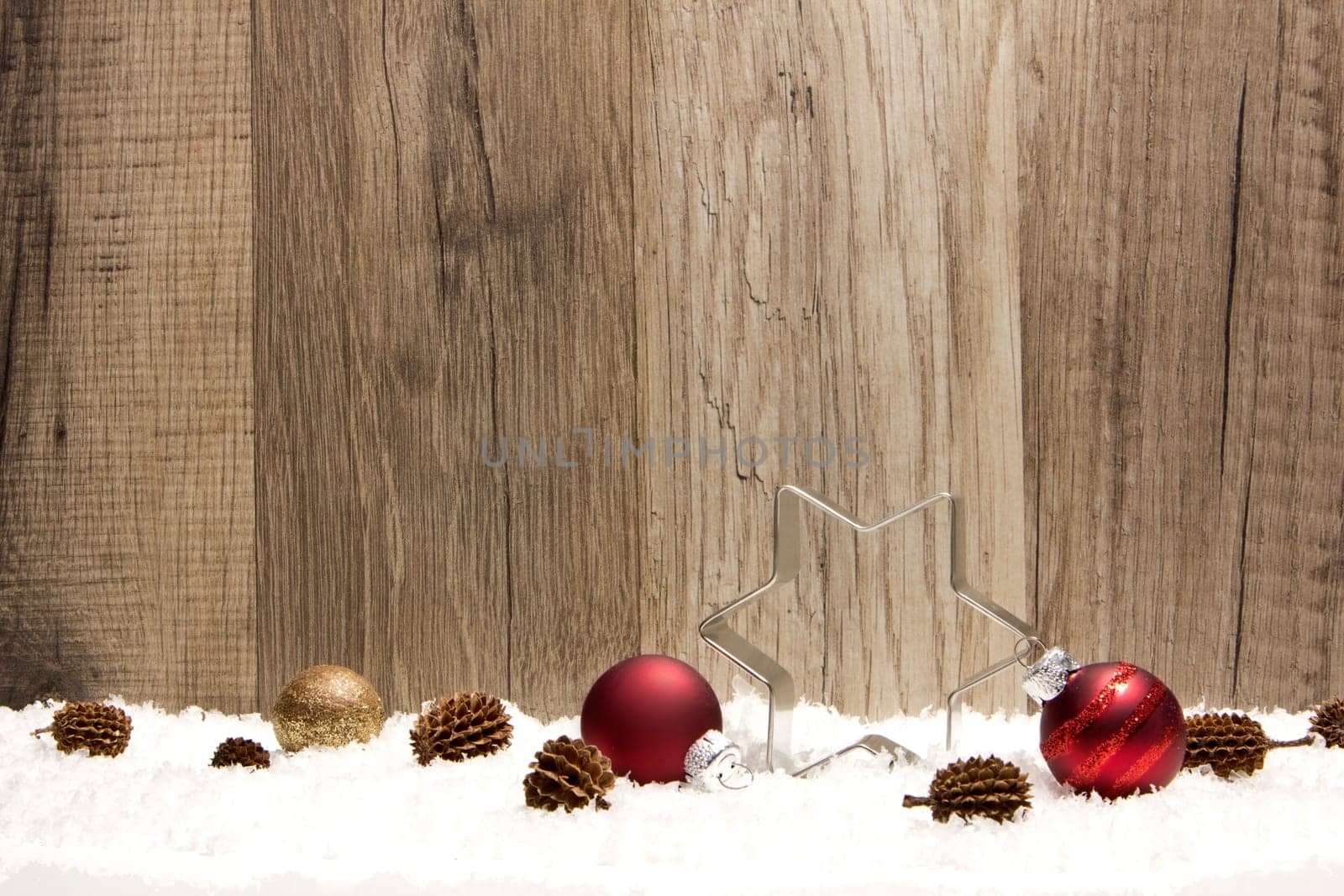 Christmas,decoration with wooden background,snow,Christmas baubles red,gold and pine cones
