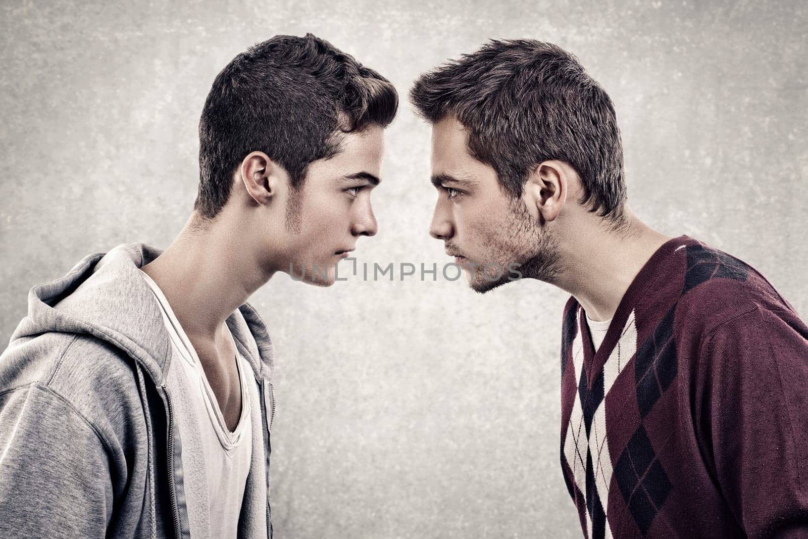 Two young angry people standing face to face