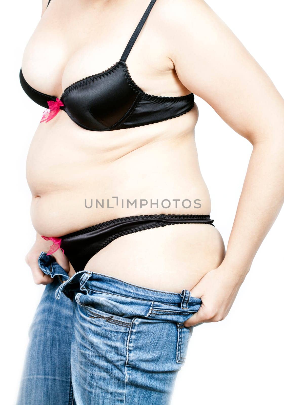 Fat woman trying to put on her tight jeans