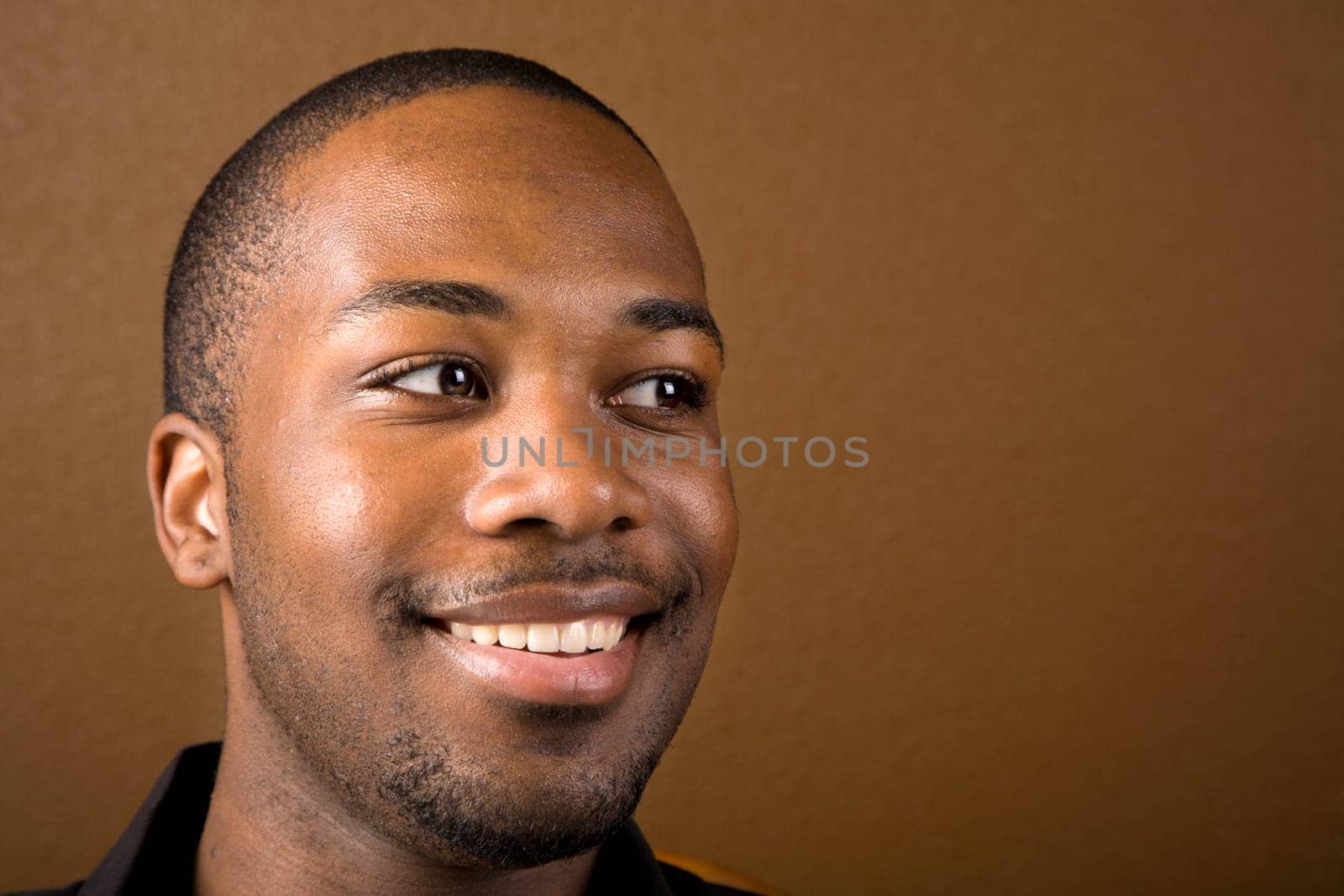 Portrait of a handsome young black man with dark background