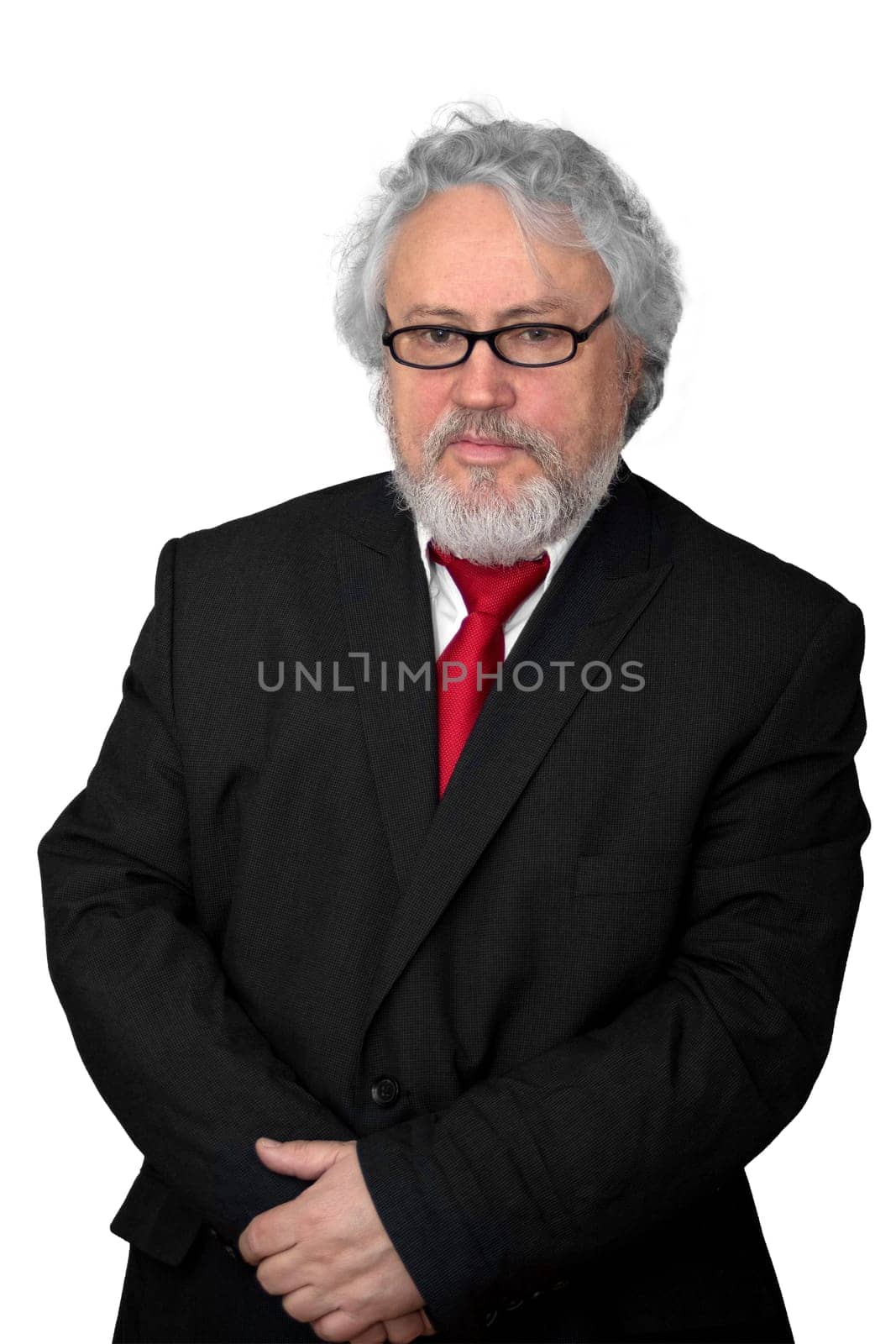 Gray haired senior wearing a dark suit and a red necktie